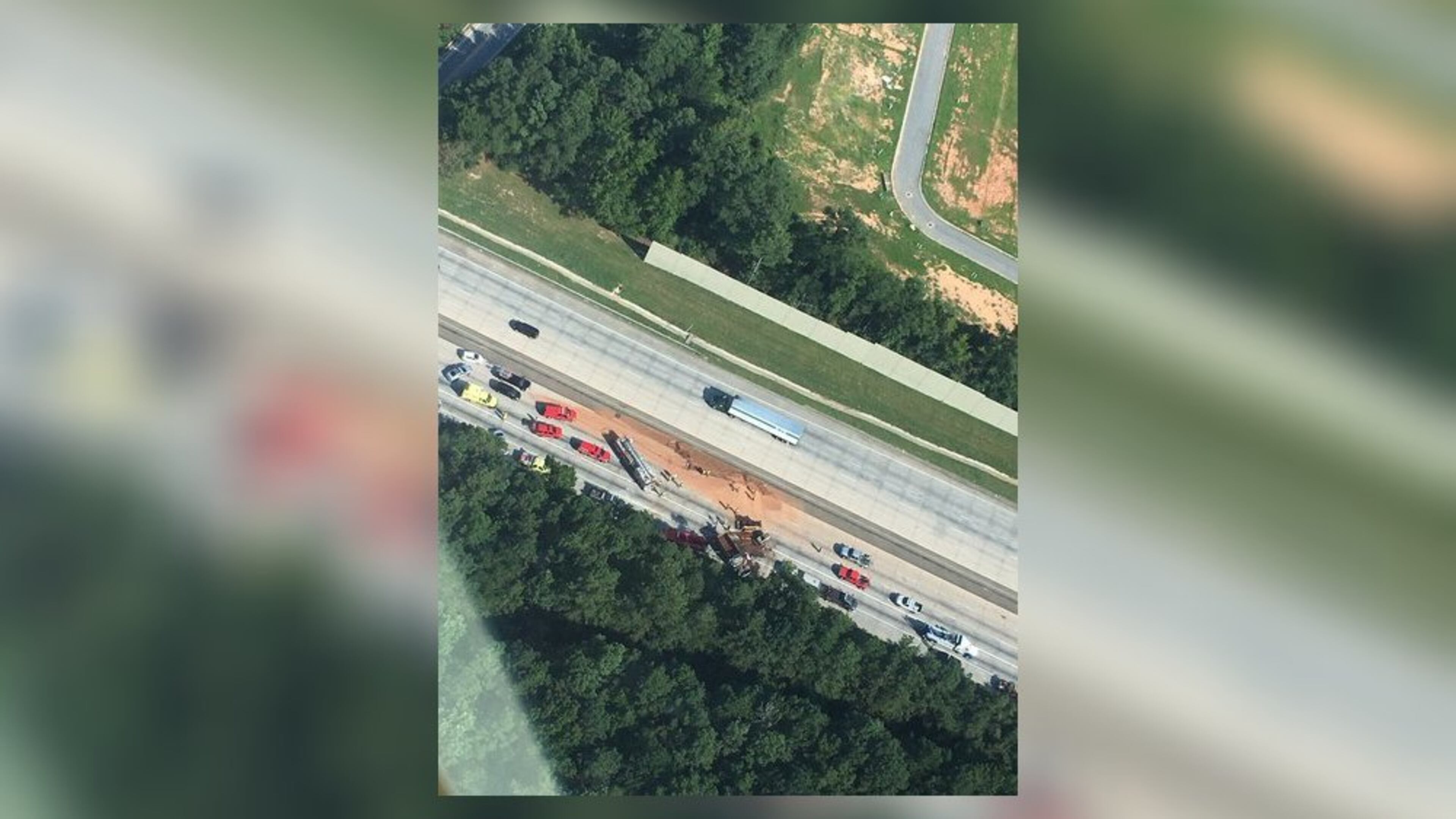 I-85 southbound was blocked for nearly two hours Wednesday after a dump truck overturned and spilled dirt on the interstate. (Credit: Channel 2 Action News)