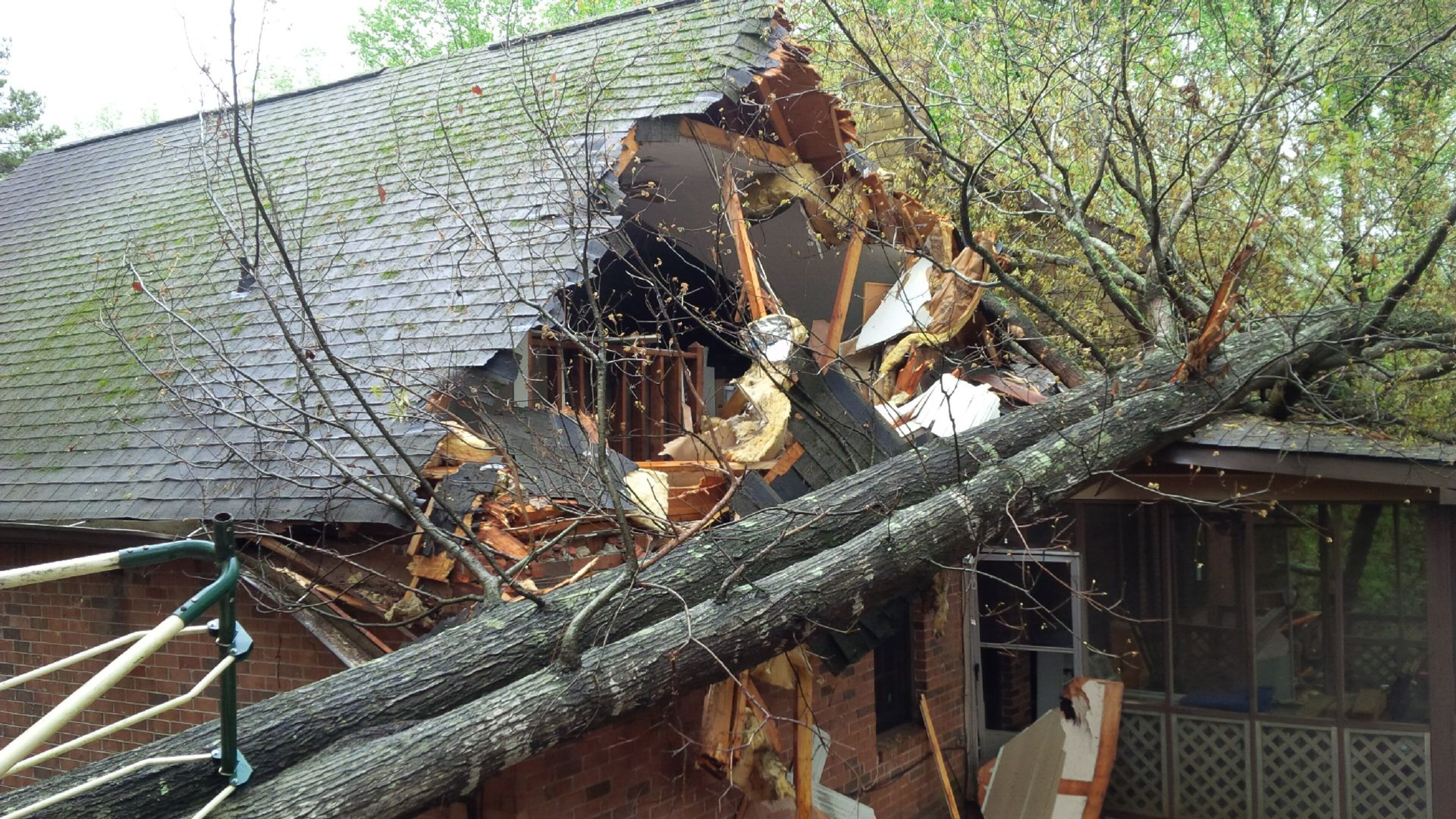 A tree fell into this house in the 1200 block of Tred Avon Way in unincorporated Lilburn on Wednesday. (Credit: Gwinnett fire)