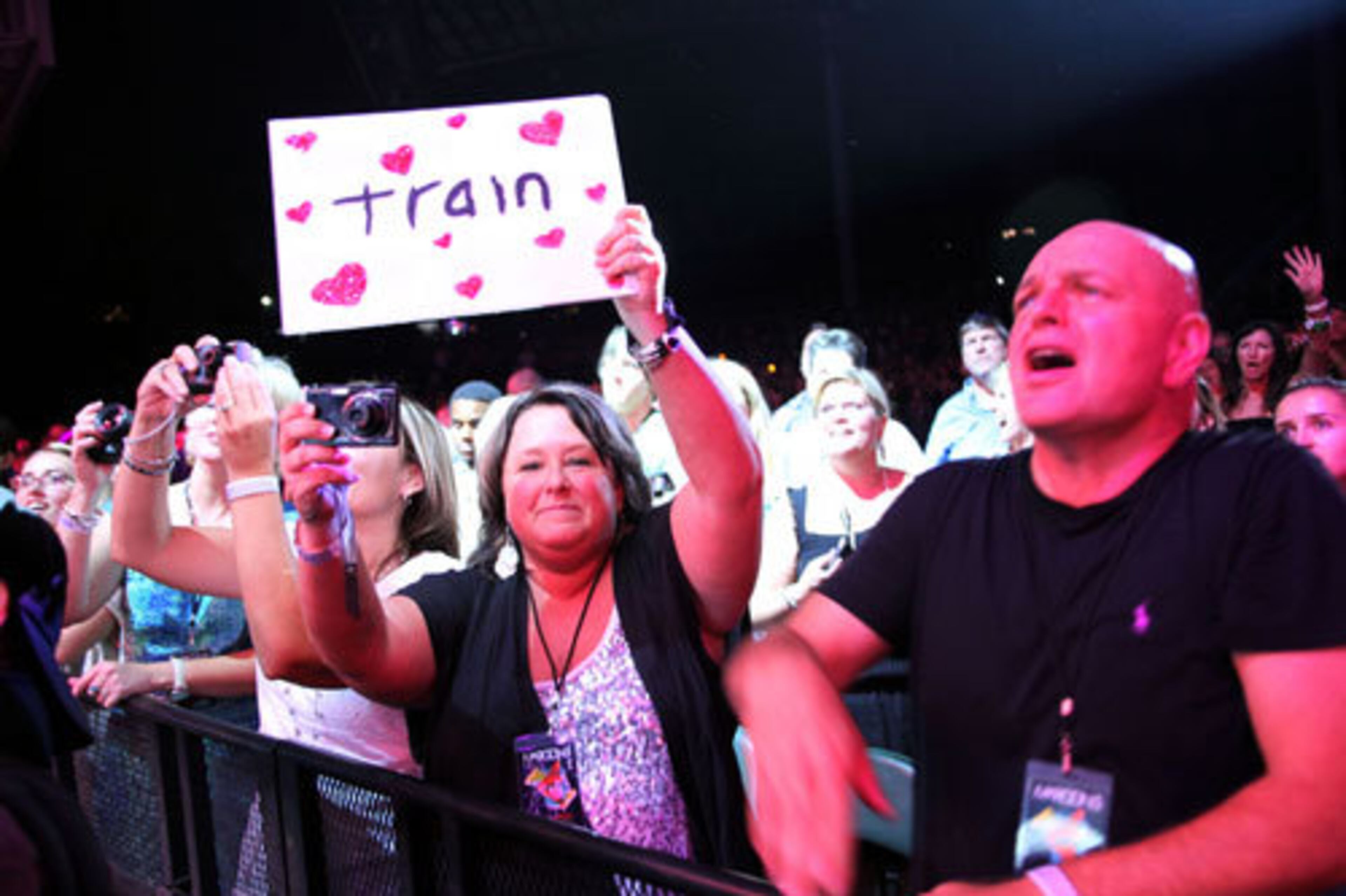 A Train fan shows her love for the band with a sign.