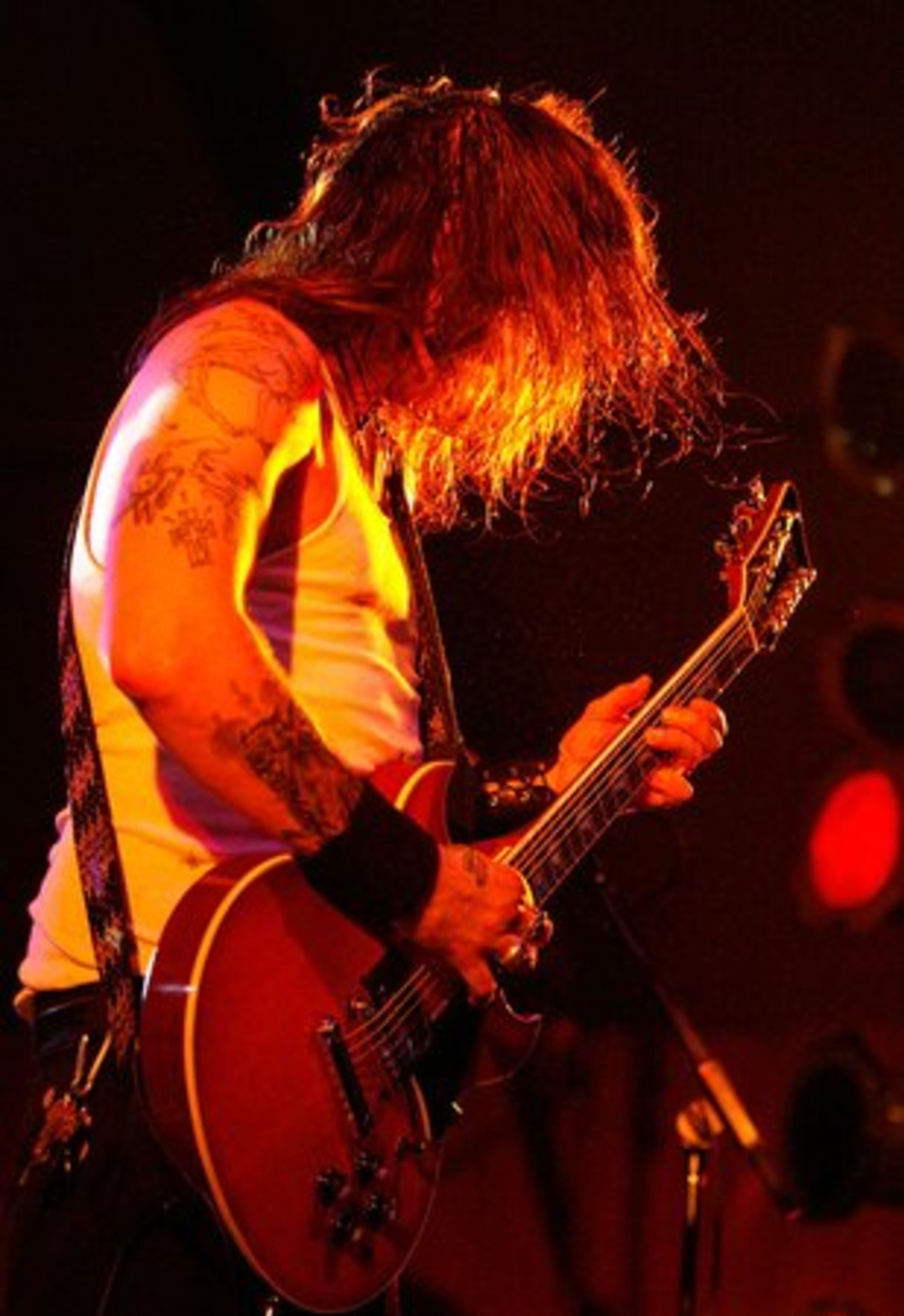 With a mass of hair flowing in the orange light, Pike performs on the outdoor stage.