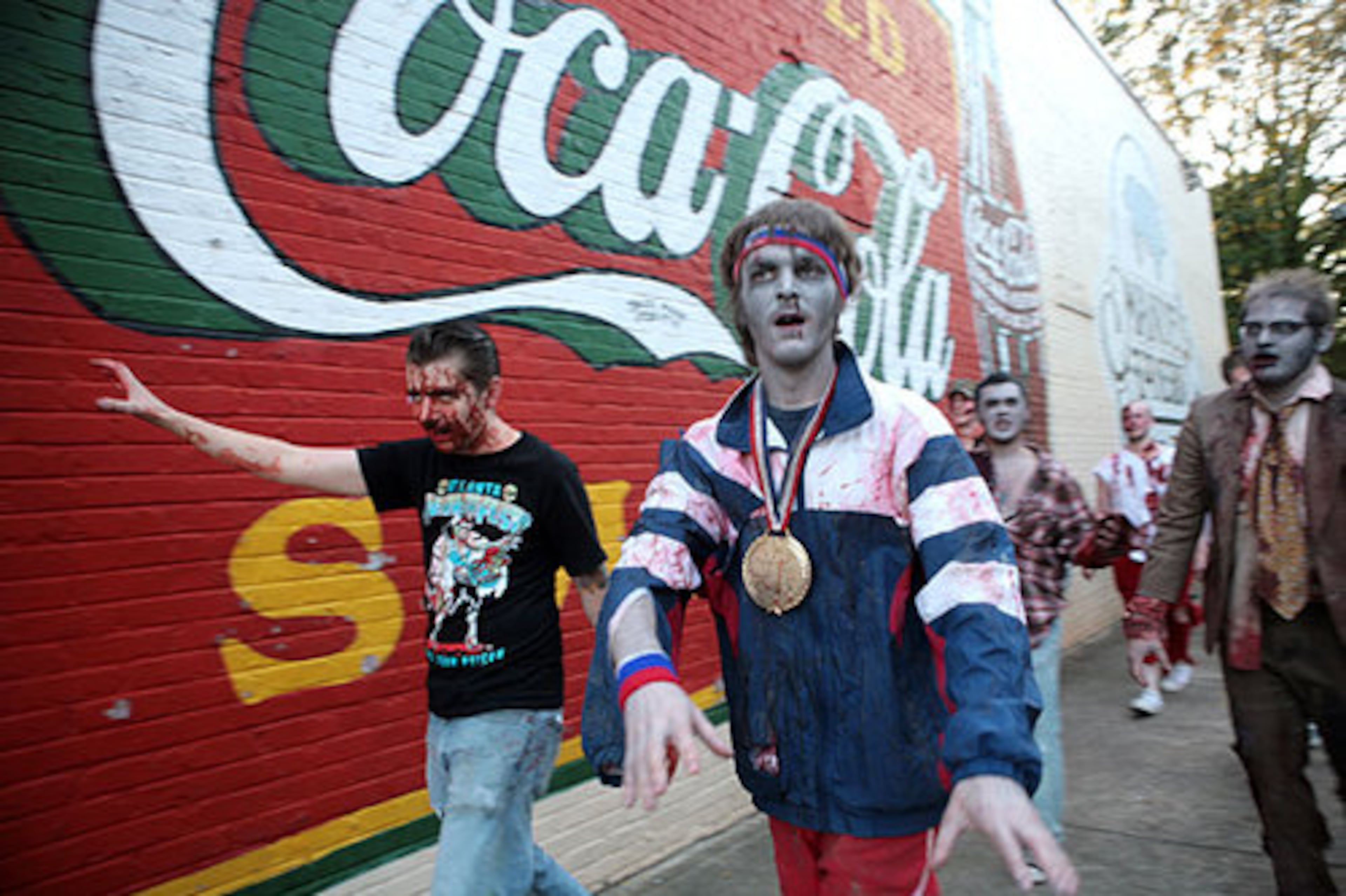 Lucas Godfrey (left), Tony Neitzol and more than 300 other people dressed as zombies walk along North Avenue past Manuel's Tavern during Atlanta Horrorfest's Zombie Walk.