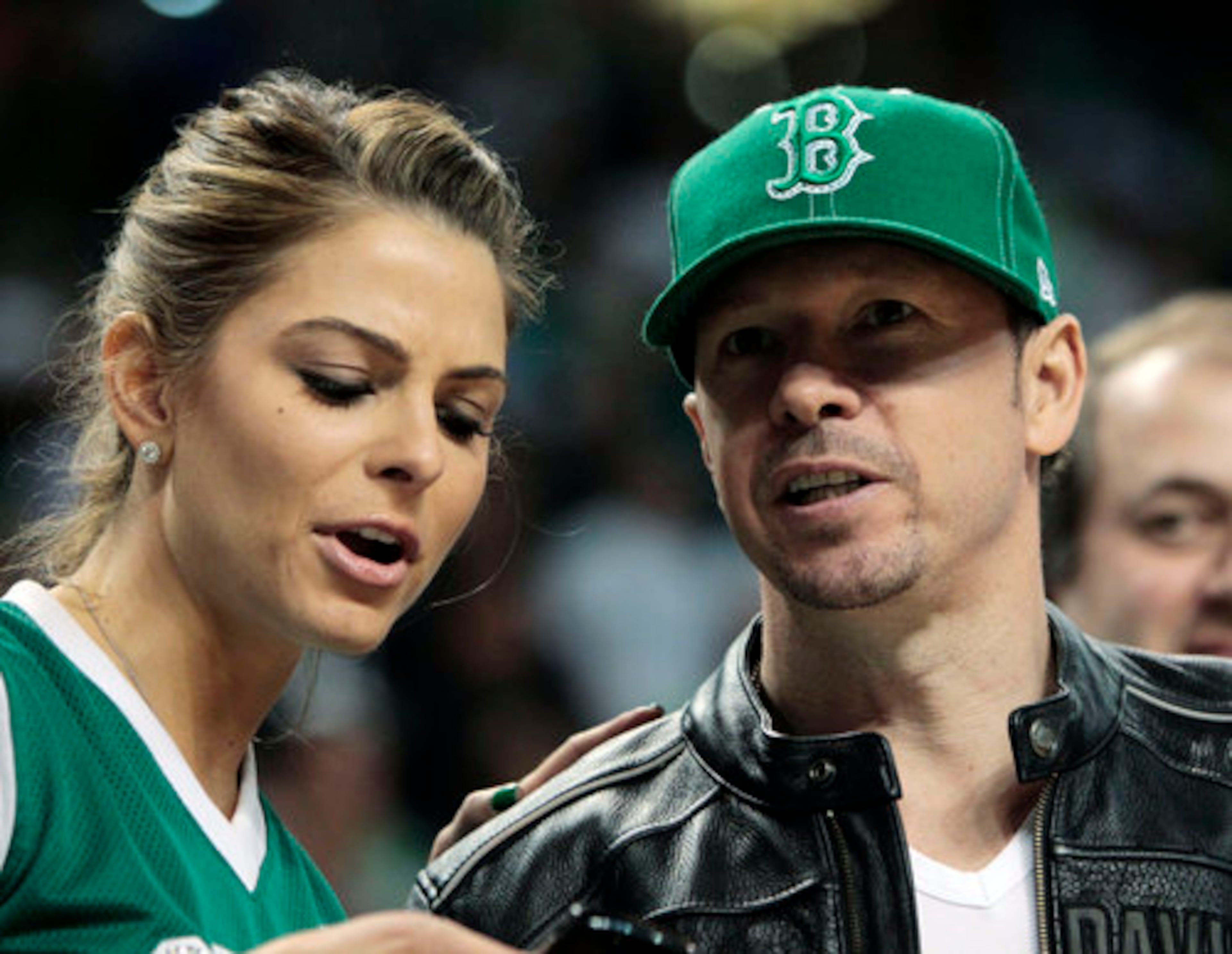 Television personality Maria Menounos (left) talks to actor Donnie Wahlberg before Game 3.