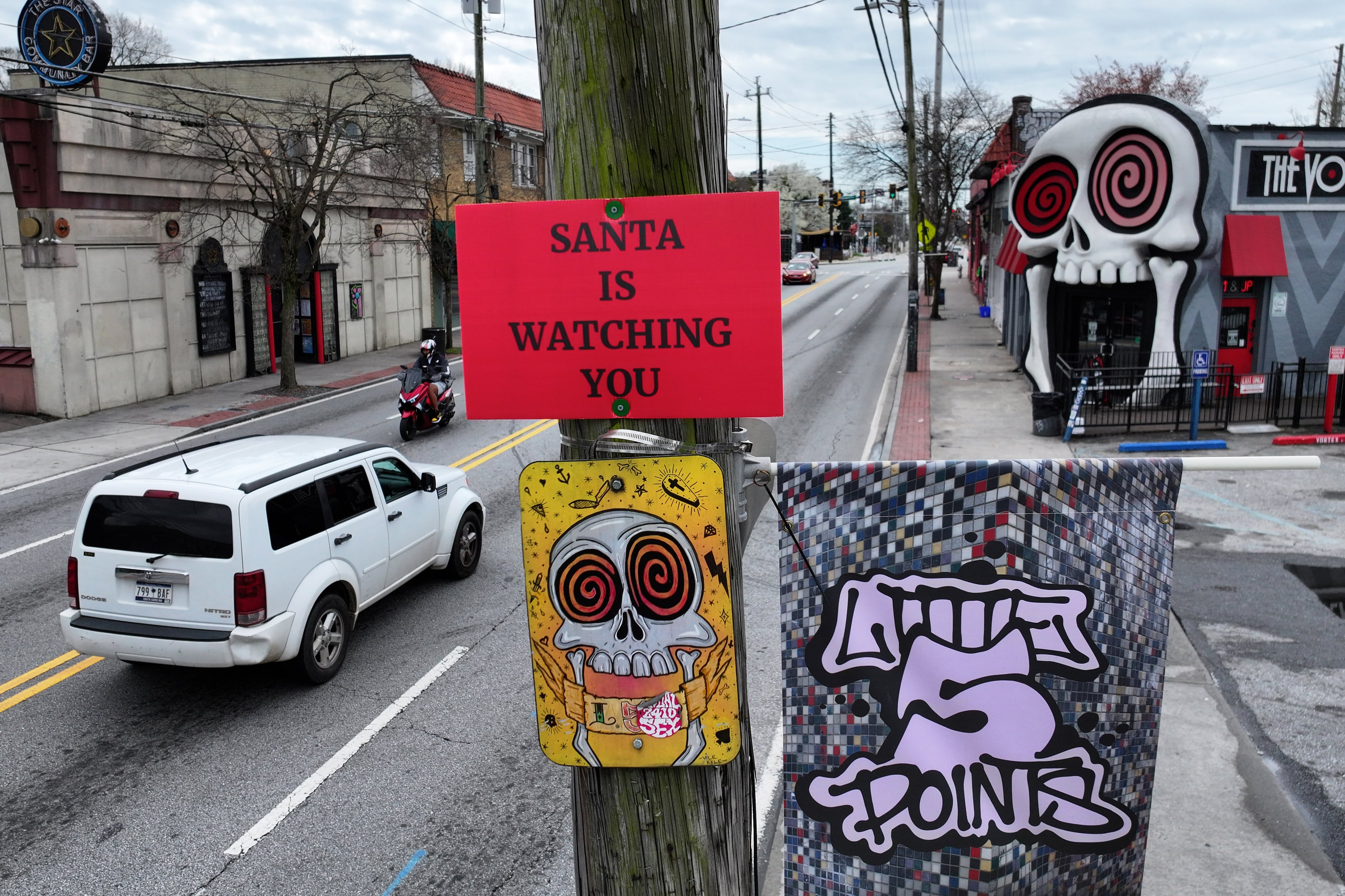 ‘SANTA IS WATCHING YOU’ sign is seen on utility pole on Moreland Avenue near The Vortex Bar and Grill, Tuesday, March 10, 2026, in Atlanta. The story is about mysterious signs high on utility poles around the east side of Atlanta. The signs say SANTA IS WATCHING YOU.(Hyosub Shin/AJC)