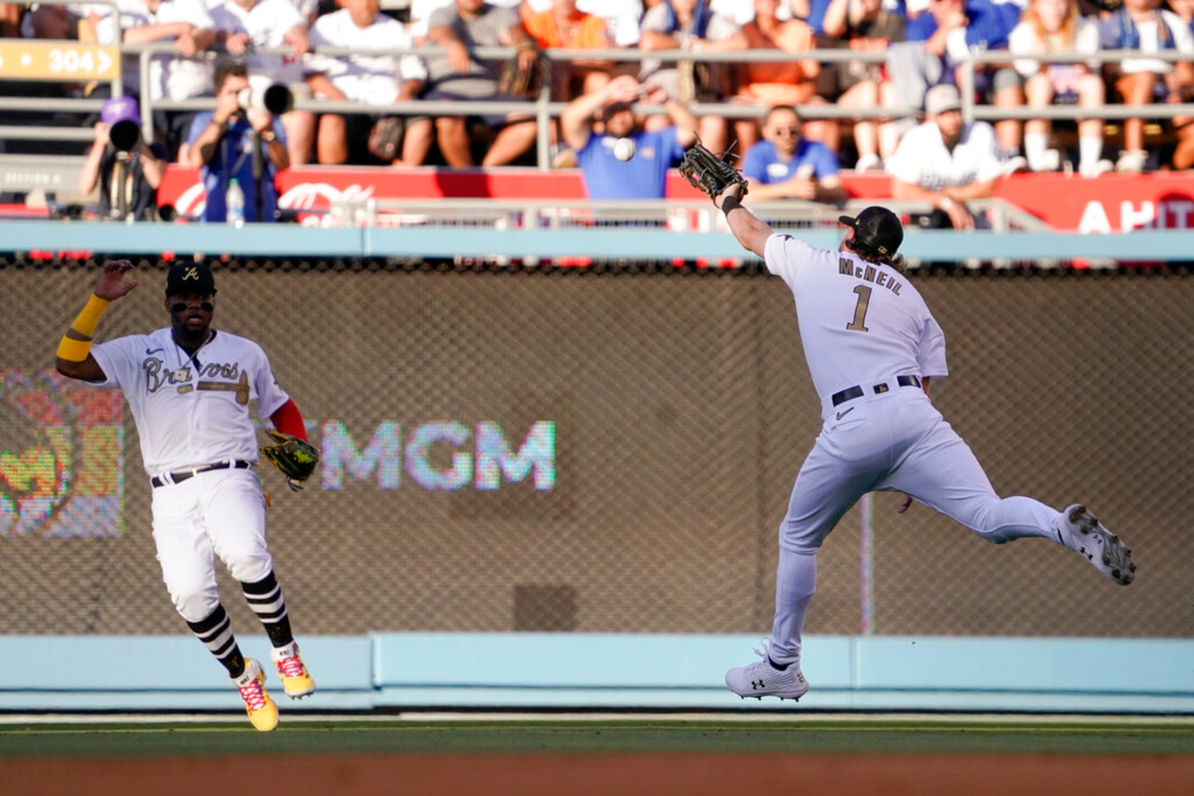 National League second baseman Jeff McNeil (1), of the New York Mets, and outfielder Ronald Acuna Jr., of the Atlanta Braves, chase a single by American League's Jose Ramirez, of the Cleveland Guardians, during the fifth inning of the MLB All-Star baseball game, Tuesday, July 19, 2022, in Los Angeles. (AP Photo/Mark J. Terrill)