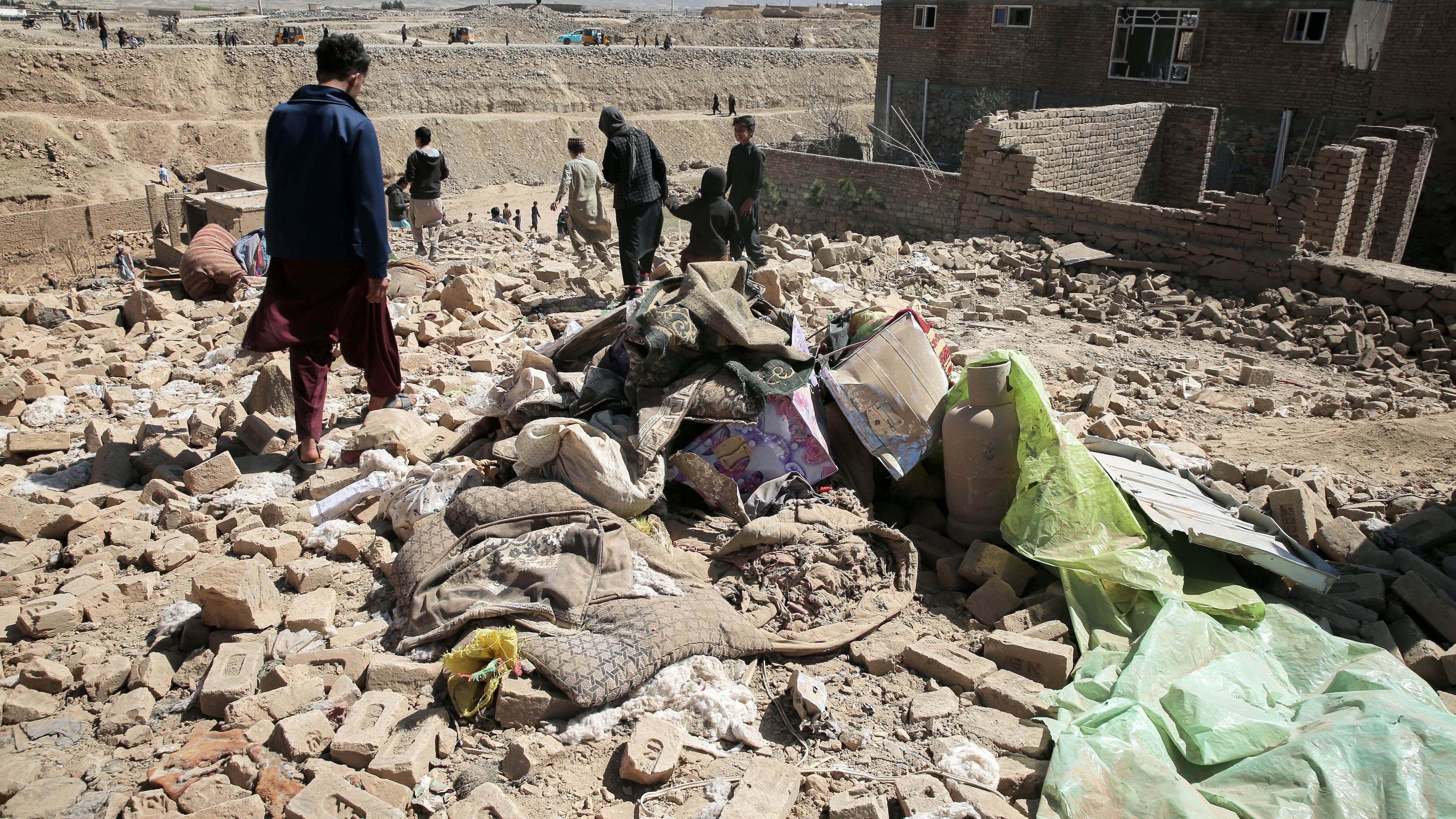 Residents inspect the site of a strike in Kabul, Afghanistan, Friday, March 13, 2026. (AP Photo/Barackatullah Popal)