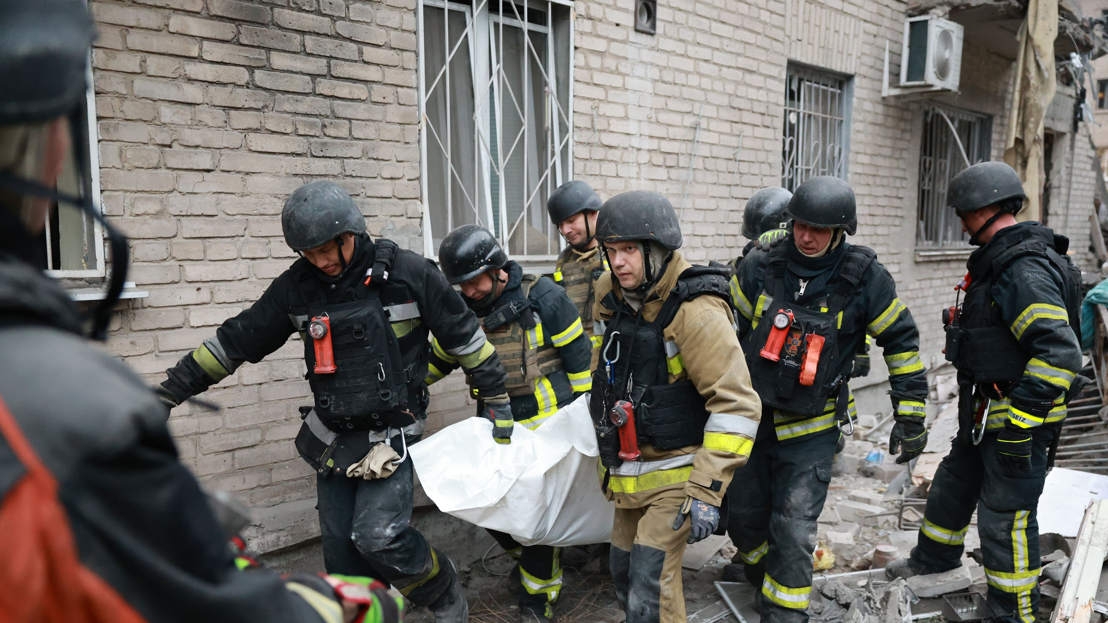 Rescue workers carry a body after pulling from the rubble of a residential building destroyed by a Russian airstrike in Zaporizhzhia, Ukraine, Saturday, Oct. 10, 2026. (AP Photo/Kateryna Klochko)