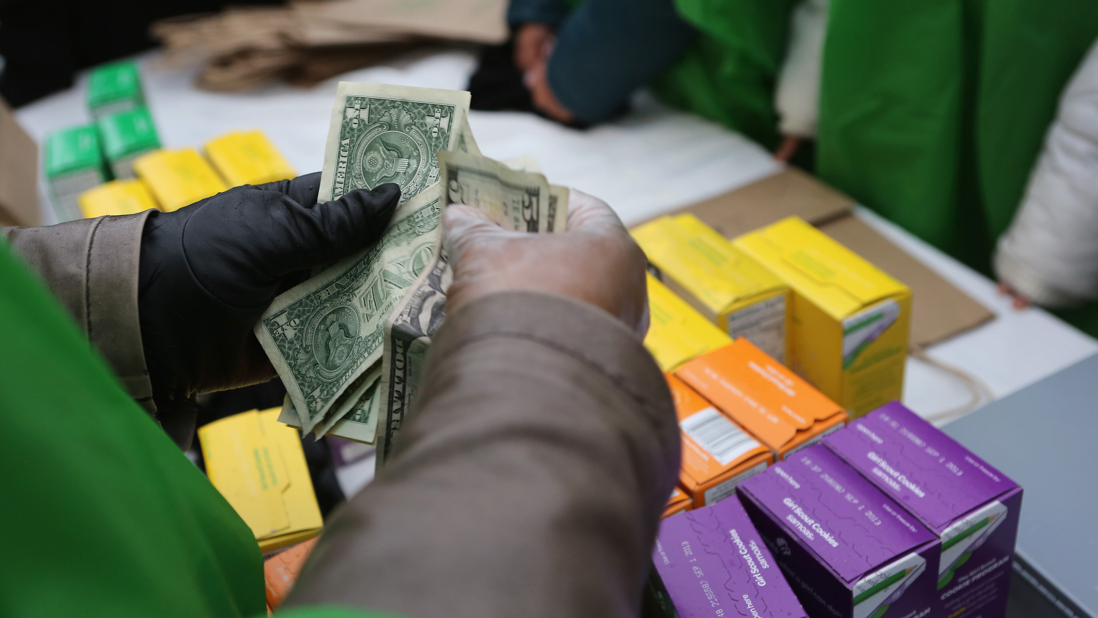 NEW YORK, NY - FEBRUARY 08: Money is collected as Girl Scouts sell cookies while a winter storm moves in on February 8, 2013 in New York City. (Photo by John Moore/Getty Images)