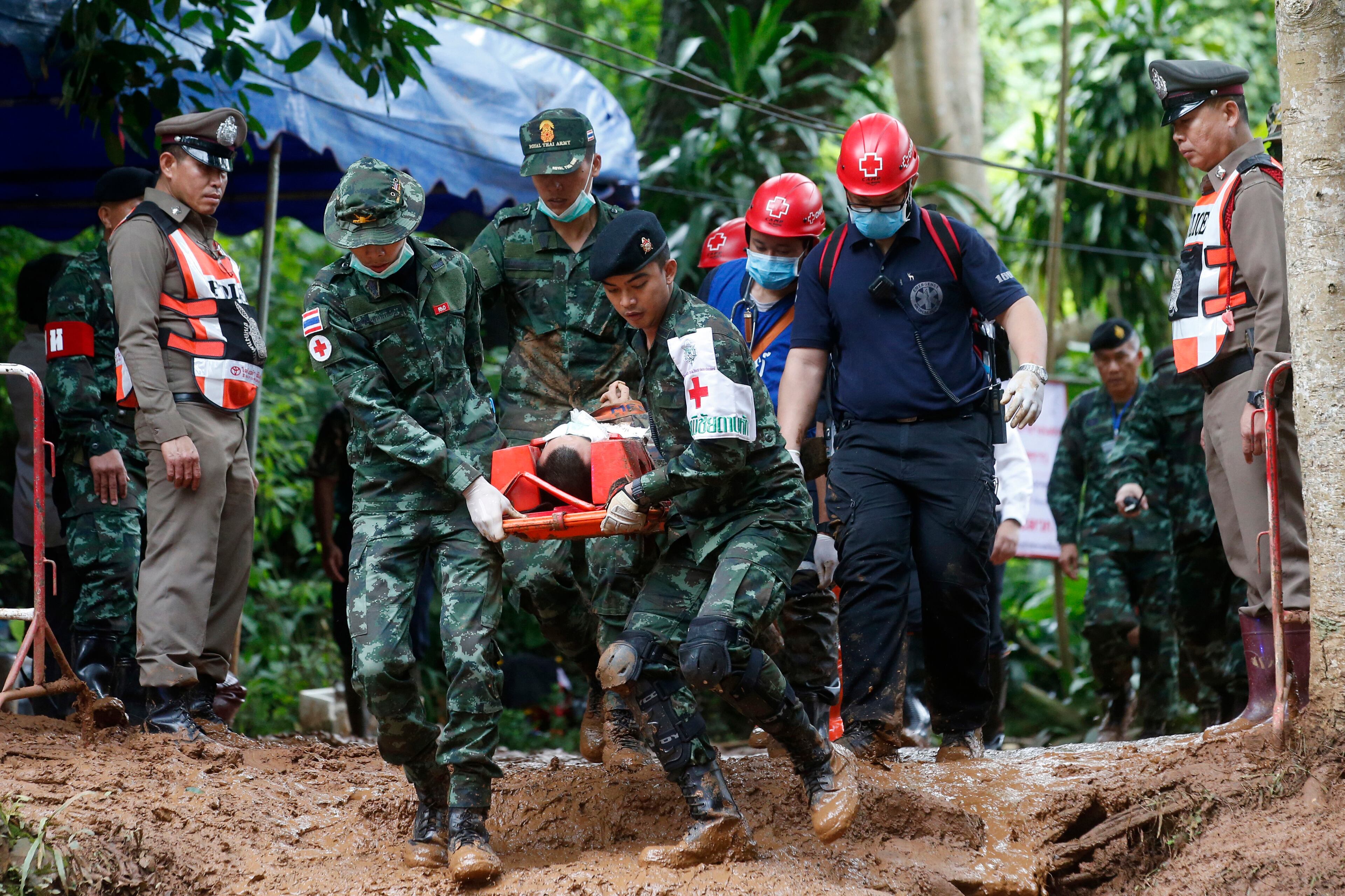 Thai soldiers hold an evacuation drill near the Tham Luang Nang Non cave in Mae Sai, Chiang Rai province, in northern Thailand Saturday, June 30, 2018. Rescuers have been searching for 12 boys and their soccer coach missing for seven days in the flooded cave complex. (AP Photo/Sakchai Lalit)