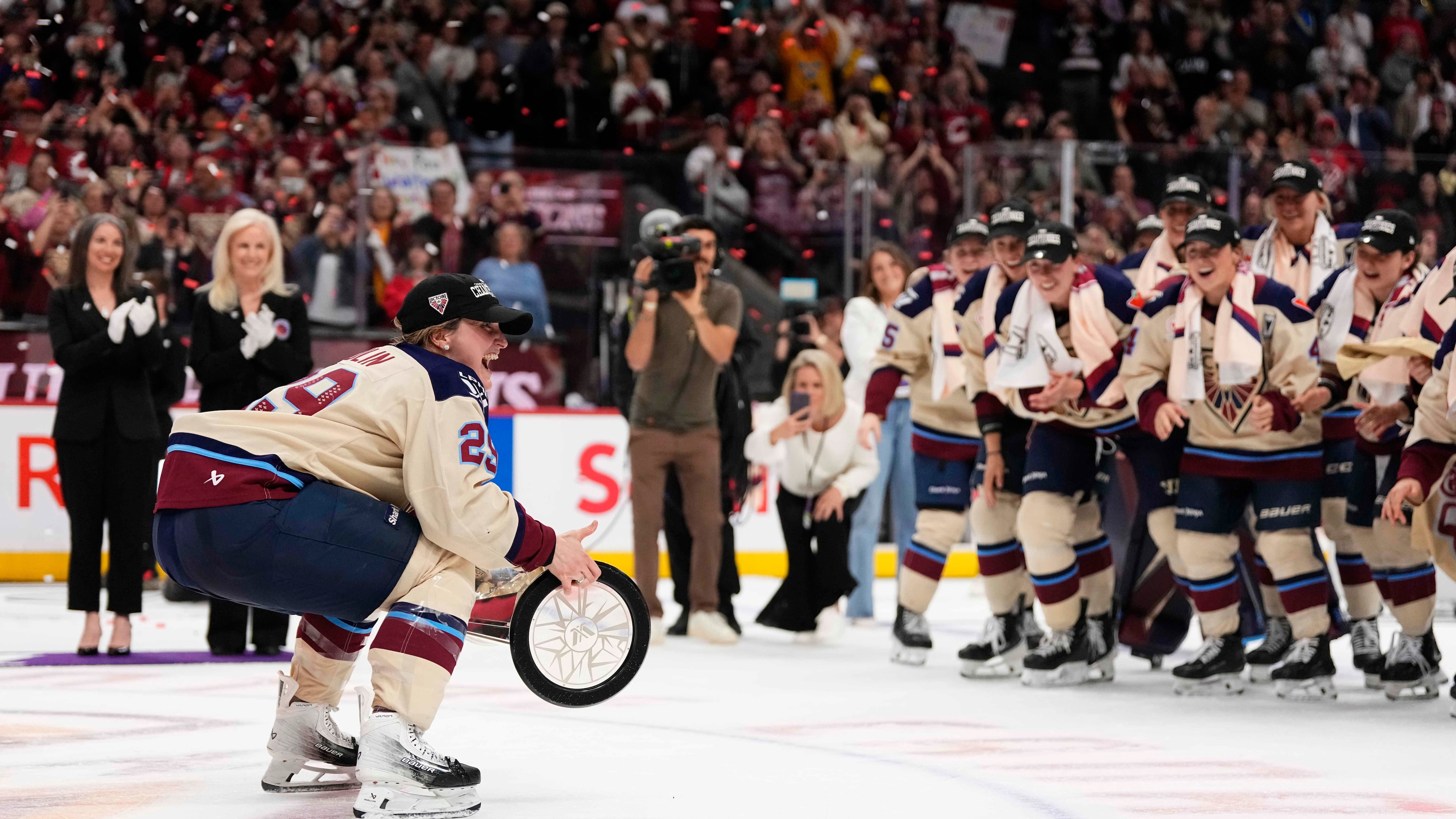 Montreal Victoire's Marie-Philip Poulin (29) carries the PWHL Walter Cup to her teammates, after the team's win against the Ottawa Charge, in Ottawa, on Wednesday, May 20, 2026. (Justin Tang/The Canadian Press via AP) CORRECTION: name of photographer Justin Tang