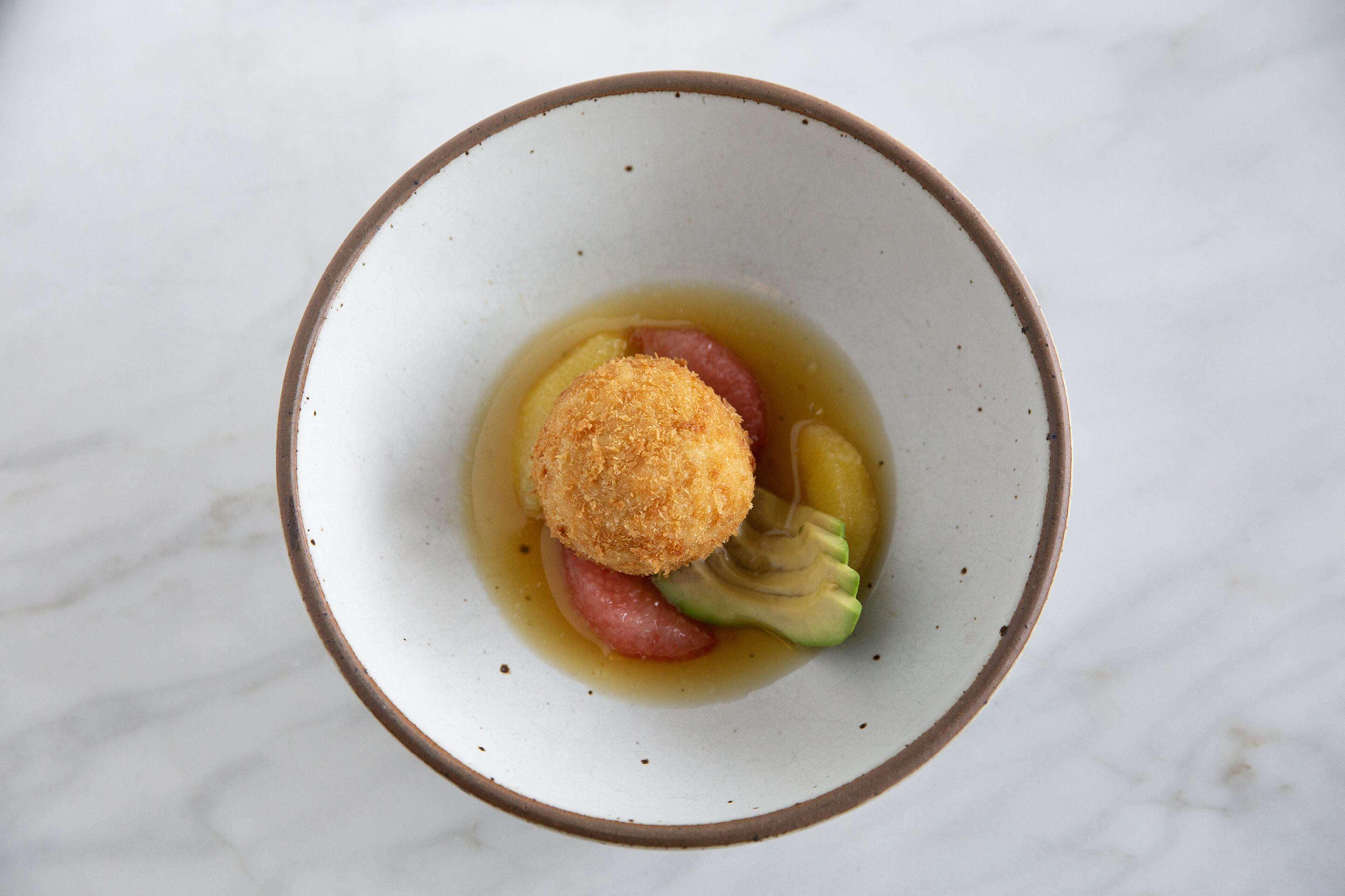 Blue Crab Fritters With Avocado, Citrus and Hot Pepper Essence is the most popular dish on Bacchanalia’s menu.