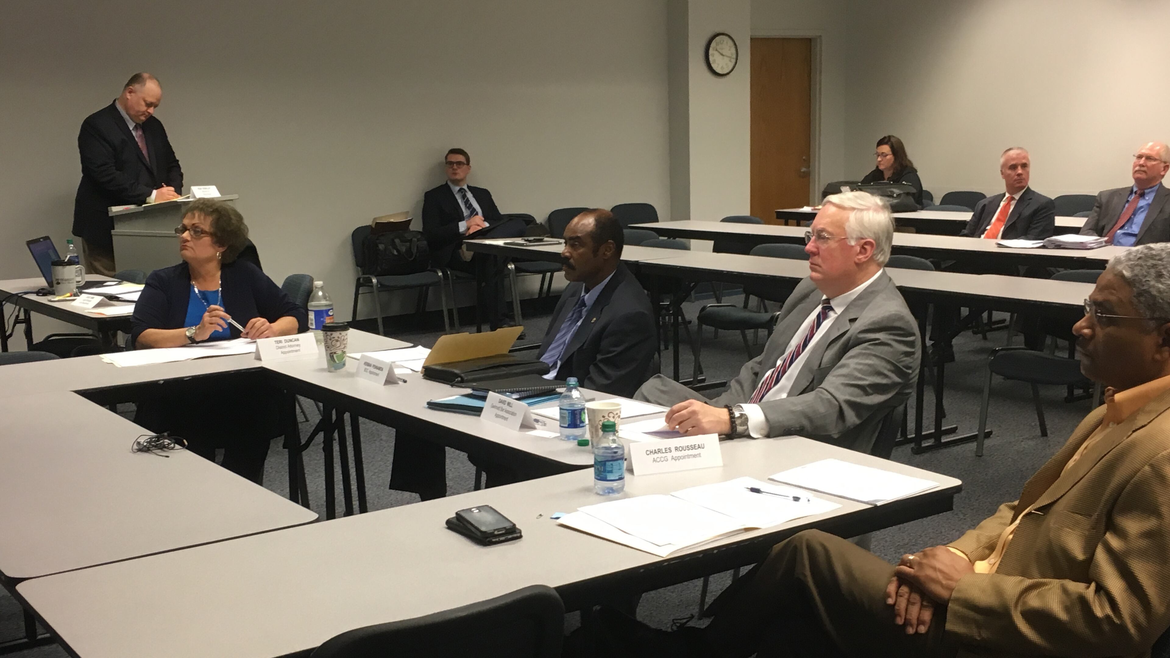 Gwinnett County ethics board members (from left) Terri R. Duncan, Herman Pennamon, David Will and Charles Rousseau watch a video on the county's ethics ordinance Friday.