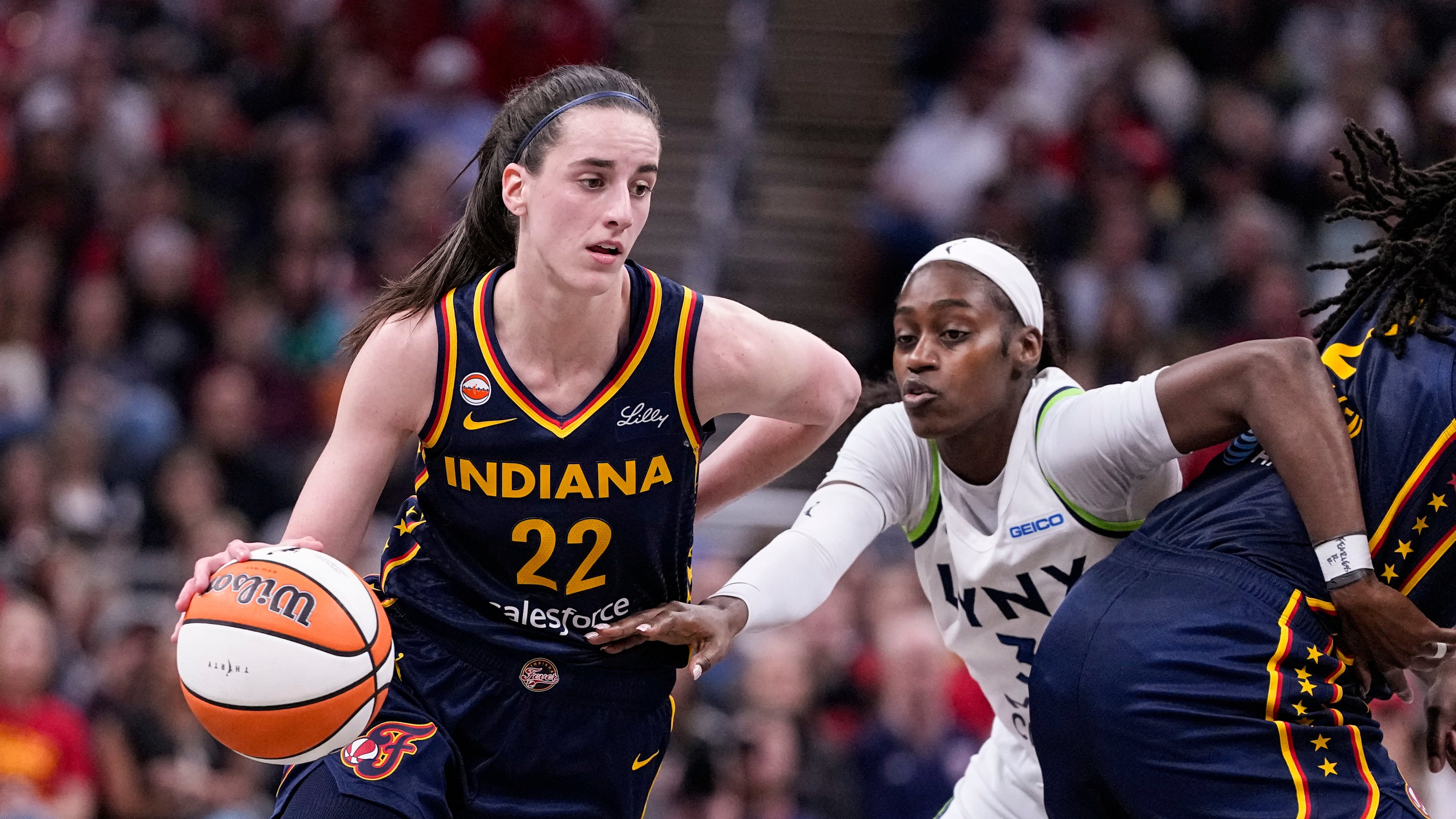 Indiana Fever guard Caitlin Clark (22) drives past Minnesota Lynx guard Maya Caldwell (3) in the second half of a WNBA basketball game in Indianapolis, Tuesday, Sept. 22, 2026. (AP Photo/Michael Conroy)