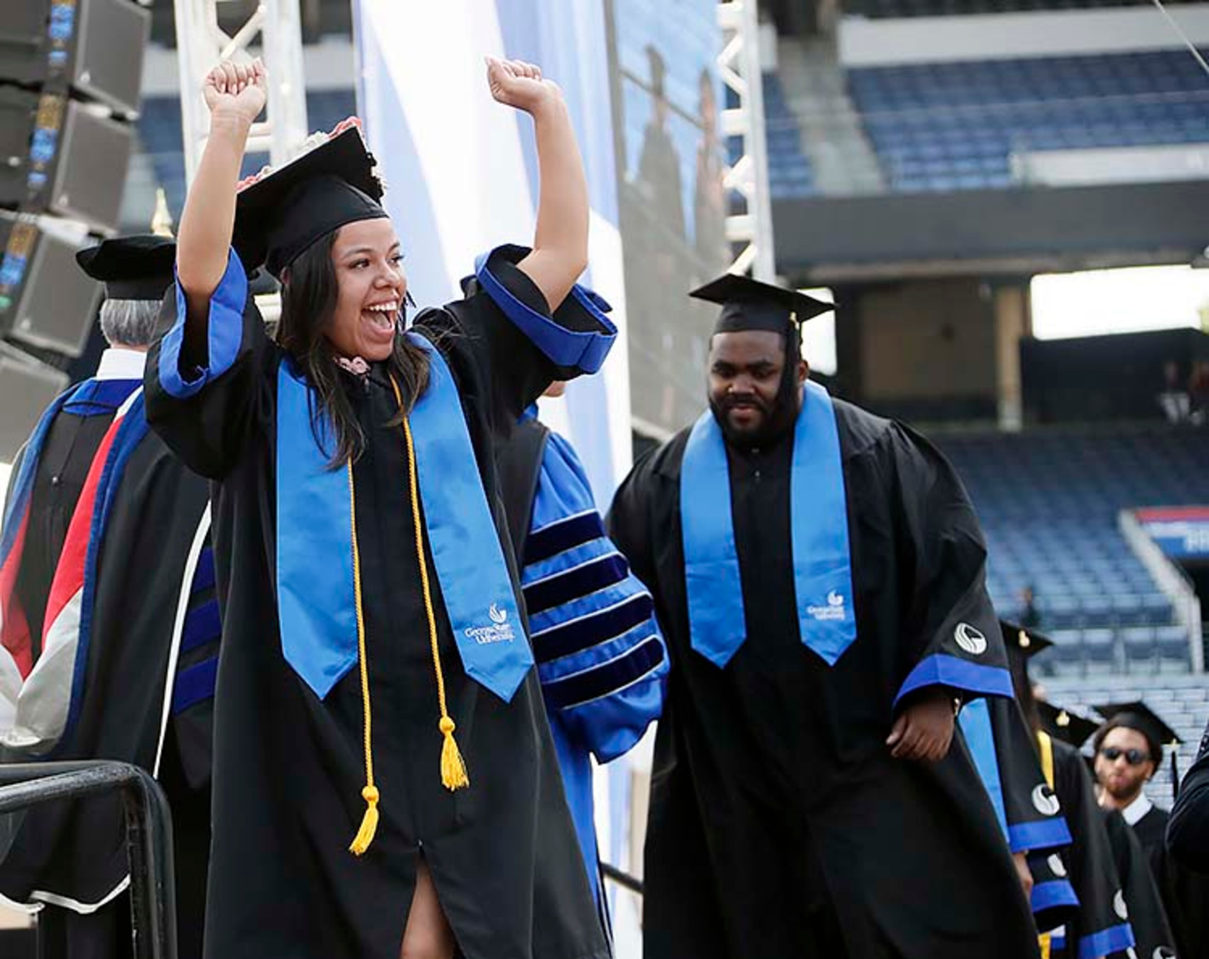May 9, 2019 - Atlanta - Graduates react in different ways as they take the stage to get their diplomas. Georgia State University is hosting its 104th Commencement Monday, May 6 through Tuesday, May 14 at Panther Stadium in Atlanta. Six schools held their graduation on Thursday. Bob Andres / bandres@ajc.com