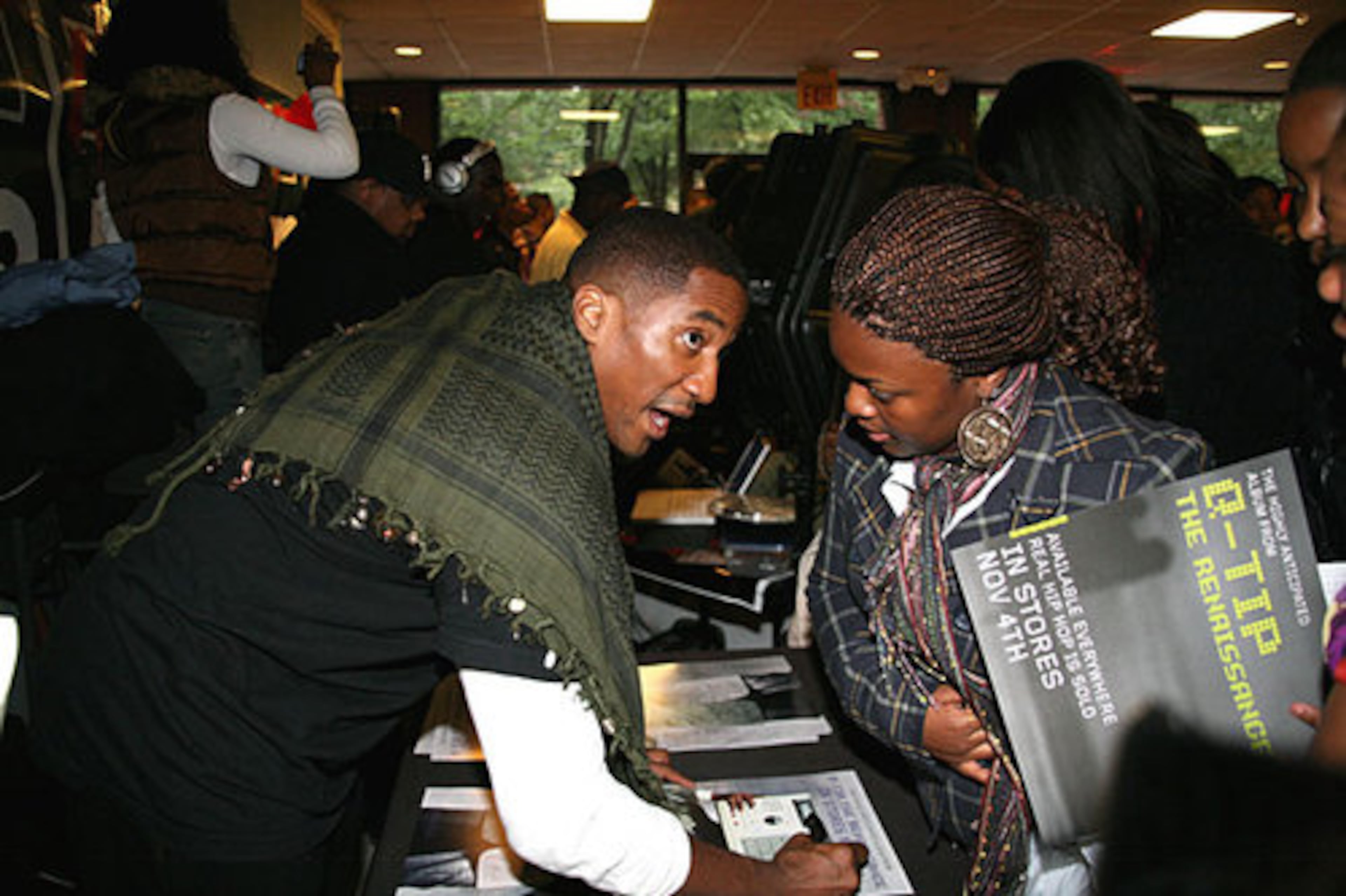 Q-Tip signs posters for fans.