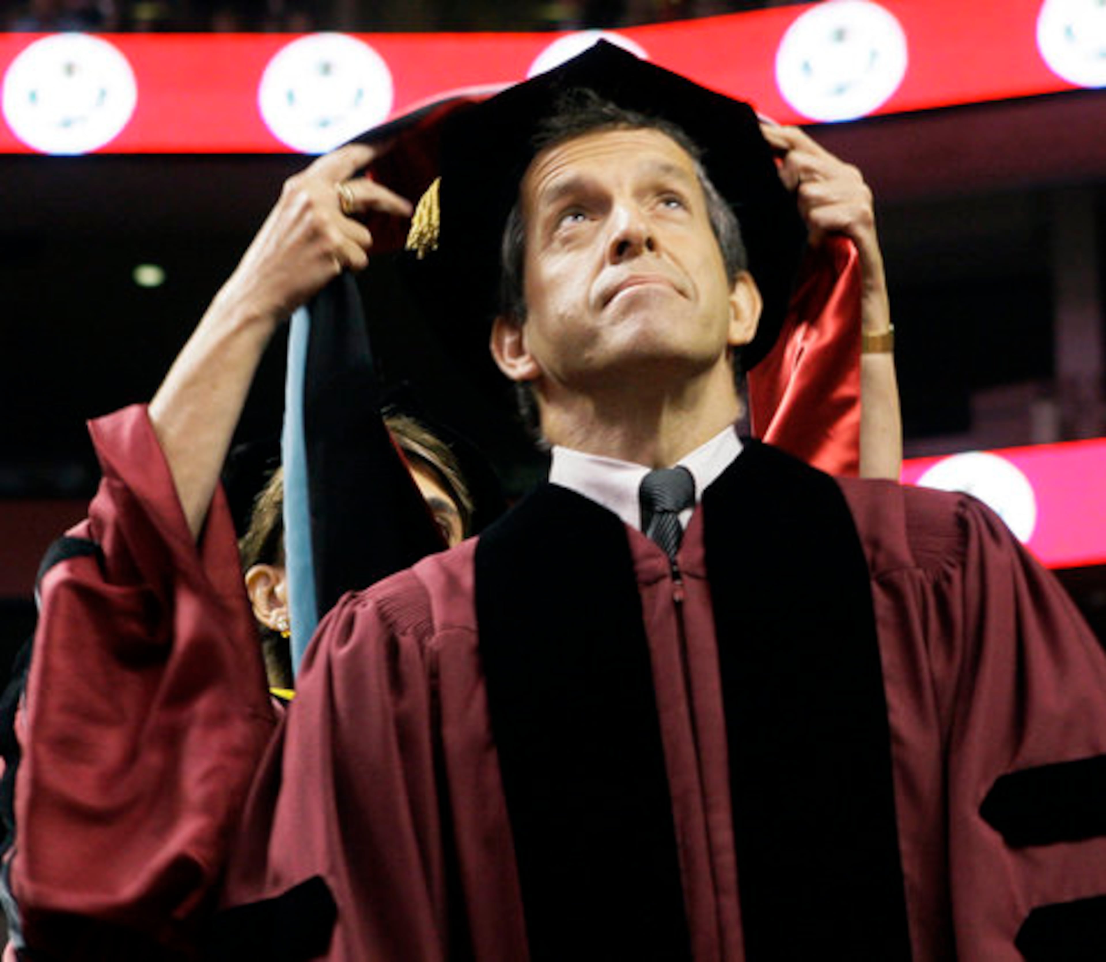 A RED RIBBON WOULD HAVE BEEN THE PERFECT ACCESSORY: Designer Kenneth Cole is hooded as he receives a Doctor of Public Service honorary degree during Northeastern University's commencement ceremony in Boston. Cole was one of the first fashion-industry leaders to publicly commit to the fight against AIDS.