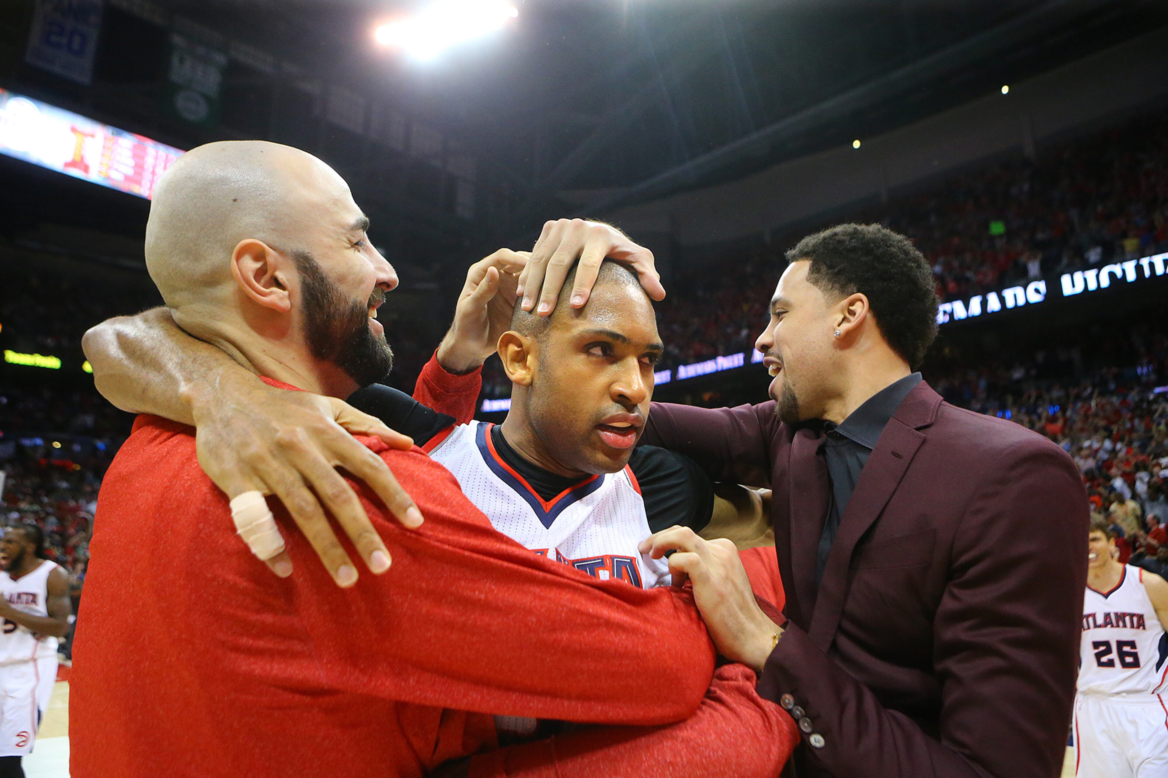 Teammates rub Al Horford on the head after he hit the game winning shot to beat the Wizards 82-81 in their Eastern Conference Semifinals game 5 on Tuesday, May 13, 2015, in Atlanta. Curtis Compton / ccompton@ajc.com