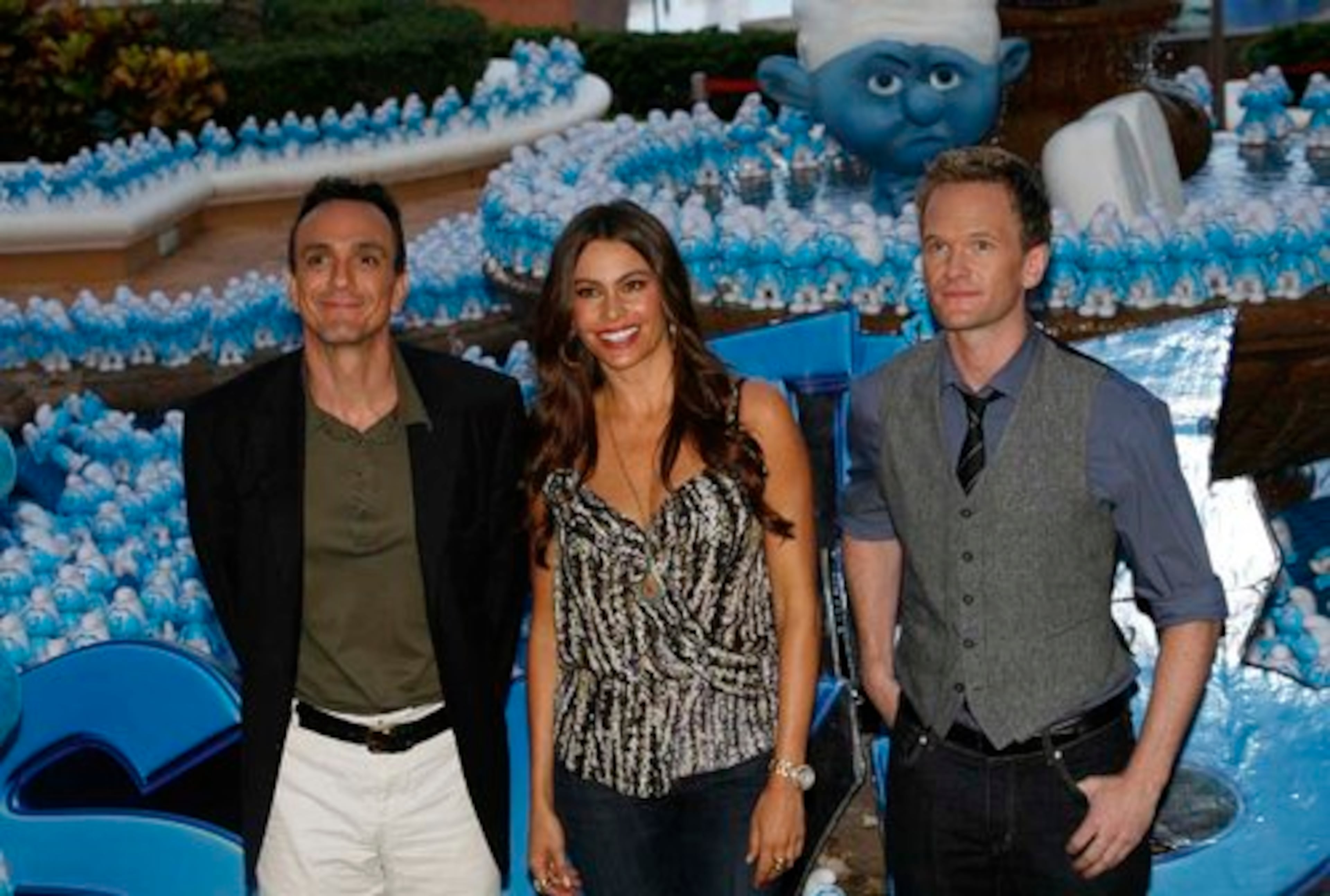Sofia Vergara is smurfed on her left by Hank Azaria (evil wizard Gargamel), and Neil Patrick Harris (the human Patrick Winslow) on her right.