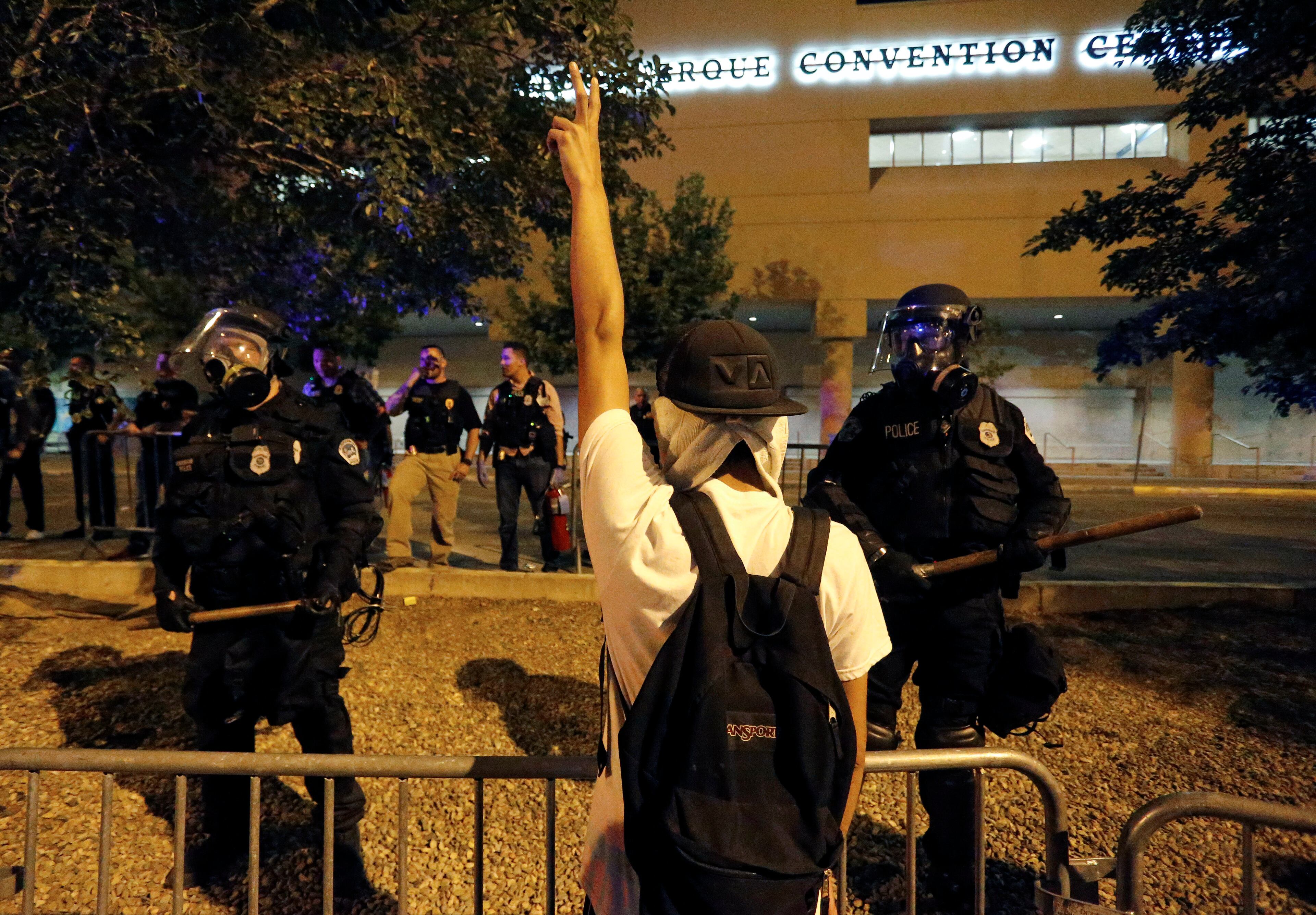 Riot police block off the Albuquerque Convention Center to anti-Trump protests following a rally and speech by Republican presidential candidate Donald Trump at the convention center where the event was held, in Albuquerque, N.M., Tuesday, May 24, 2016. (AP Photo/Brennan Linsley)