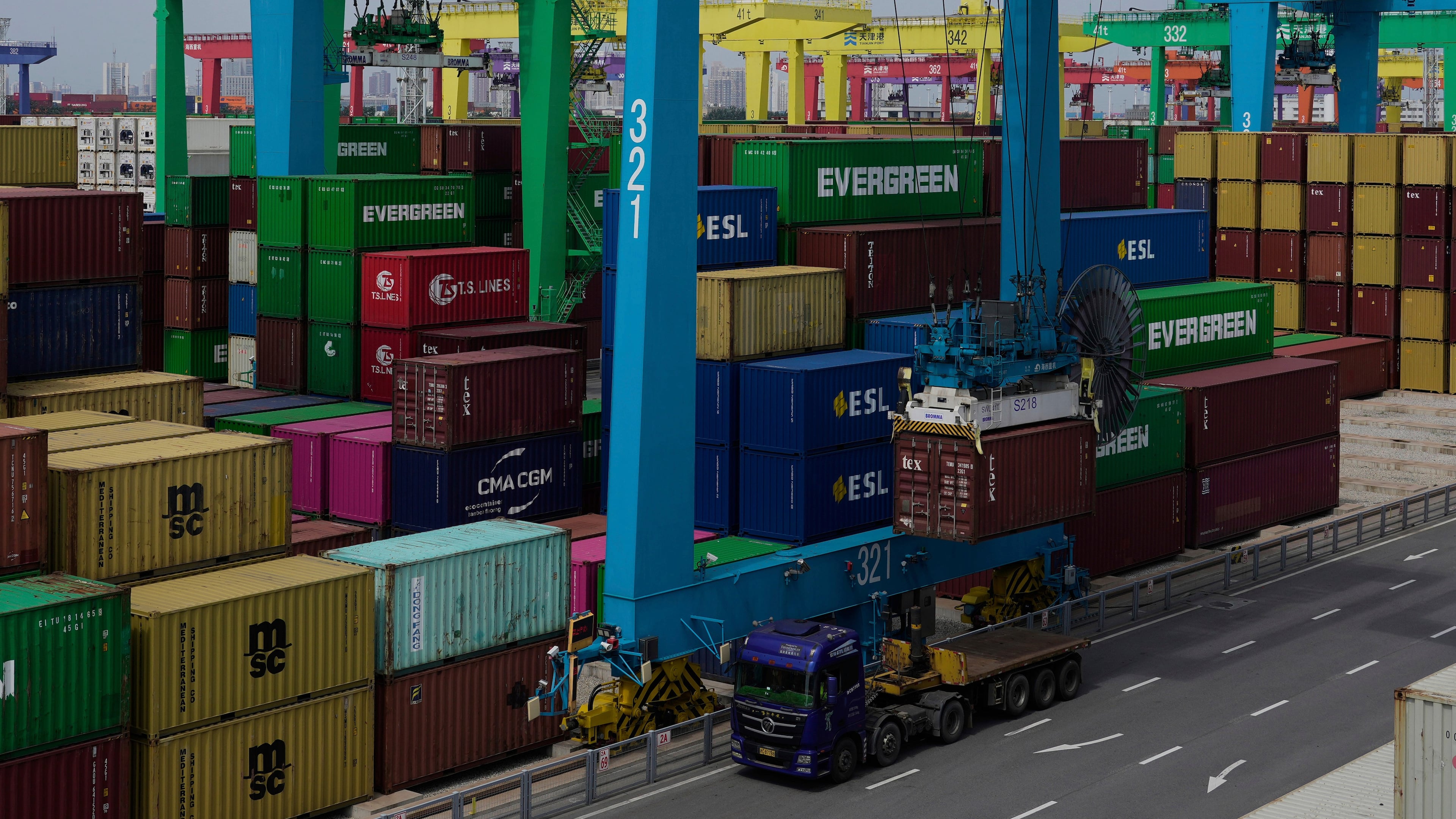 FILE - A crane loads a shipping container into a truck at an automated container port in Tianjin, China, Friday, Aug. 29, 2025. (AP Photo/Mahesh Kumar A., File)