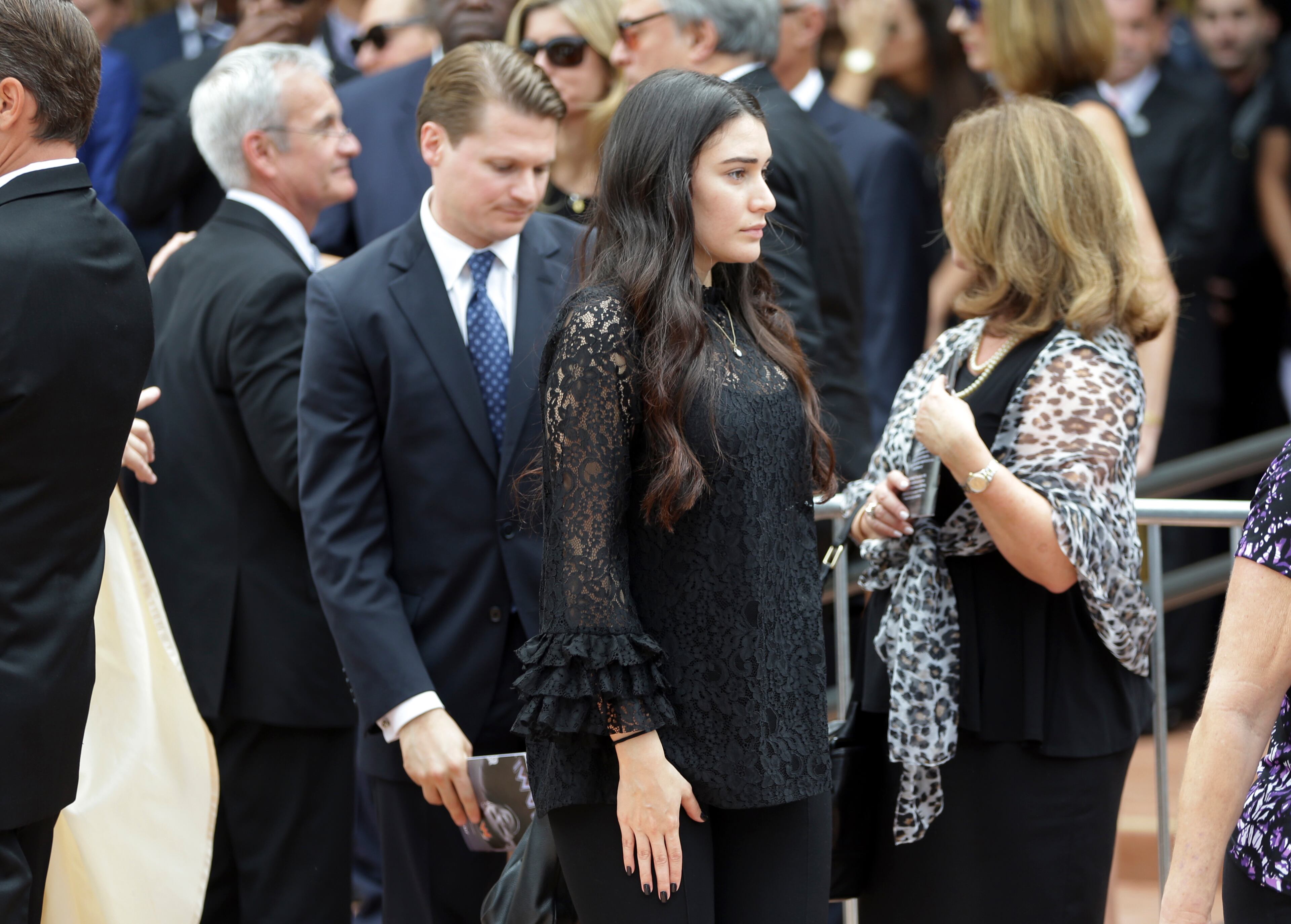 Maria Arias, the girlfriend of Miami Marlins pitcher Jose Fernandez, center, leaves a memorial service for Fernandez at St. Brendan's Catholic Church, Thursday, Sept. 29, 2016, in Miami. Fernandez was killed in a boating accident Sunday along with two friends. (AP Photo/Lynne Sladky)