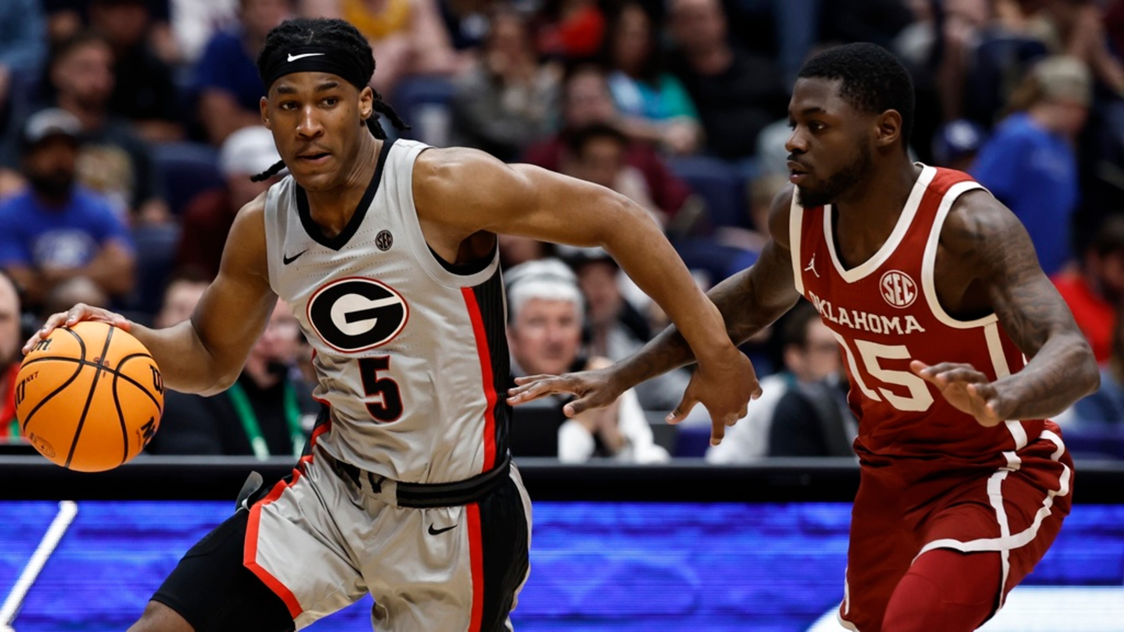 Georgia guard Silas Demary Jr. (5) moves against Oklahoma guard Duke Miles (15) during the second half of an NCAA college basketball game at the Southeastern Conference tournament, Wednesday, March 12, 2025, in Nashville, Tenn. (AP Photo/Wade Payne)