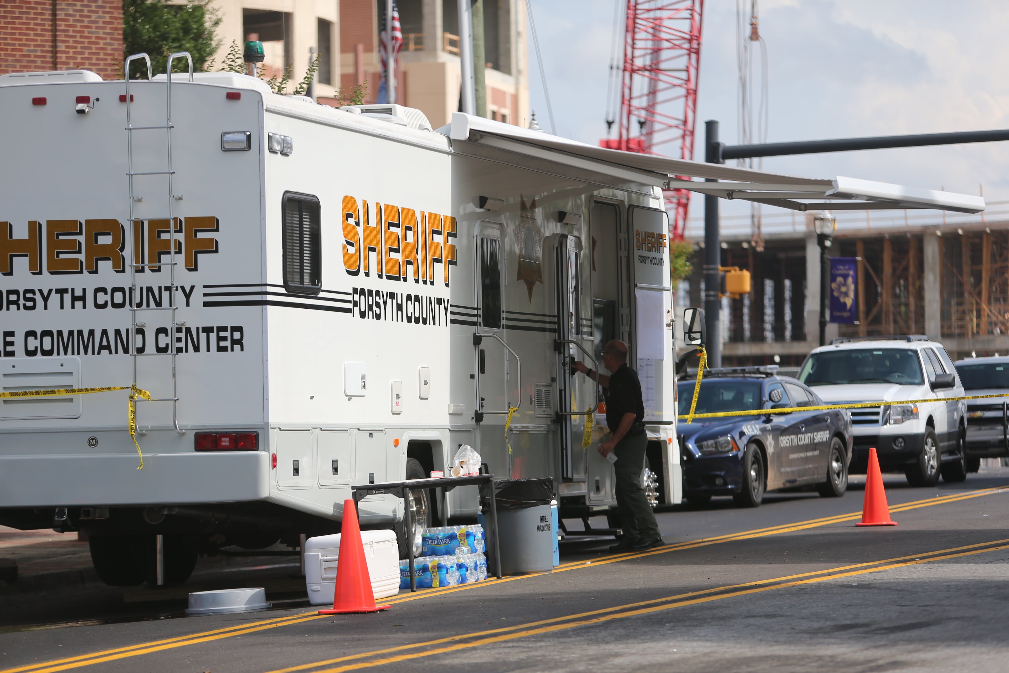 Authorities investigate the scene of shooting that took place in front of the Forsyth County courthouse in Cumming, Ga., on June 6, 2014.
