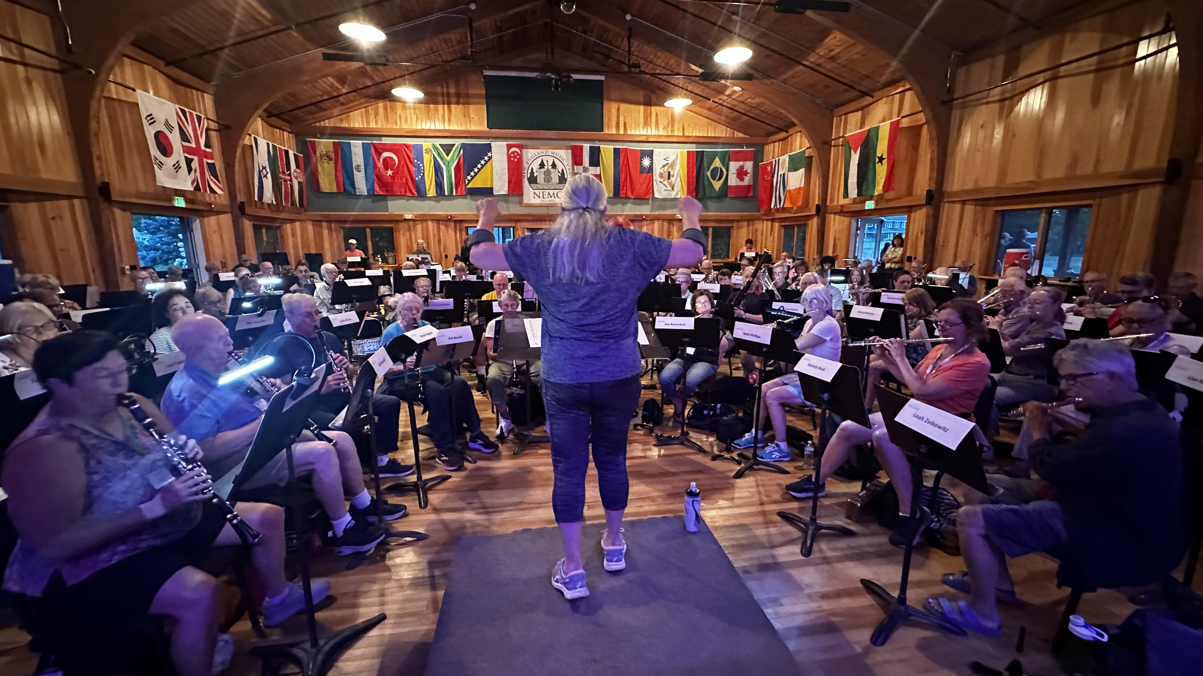 This photo provided by Russ Grazier shows conductor Debbi Gibson leading a band rehearsal at the New England Adult Music Camp in Sidney, Maine, in August 2025. (Russ Grazier via AP)