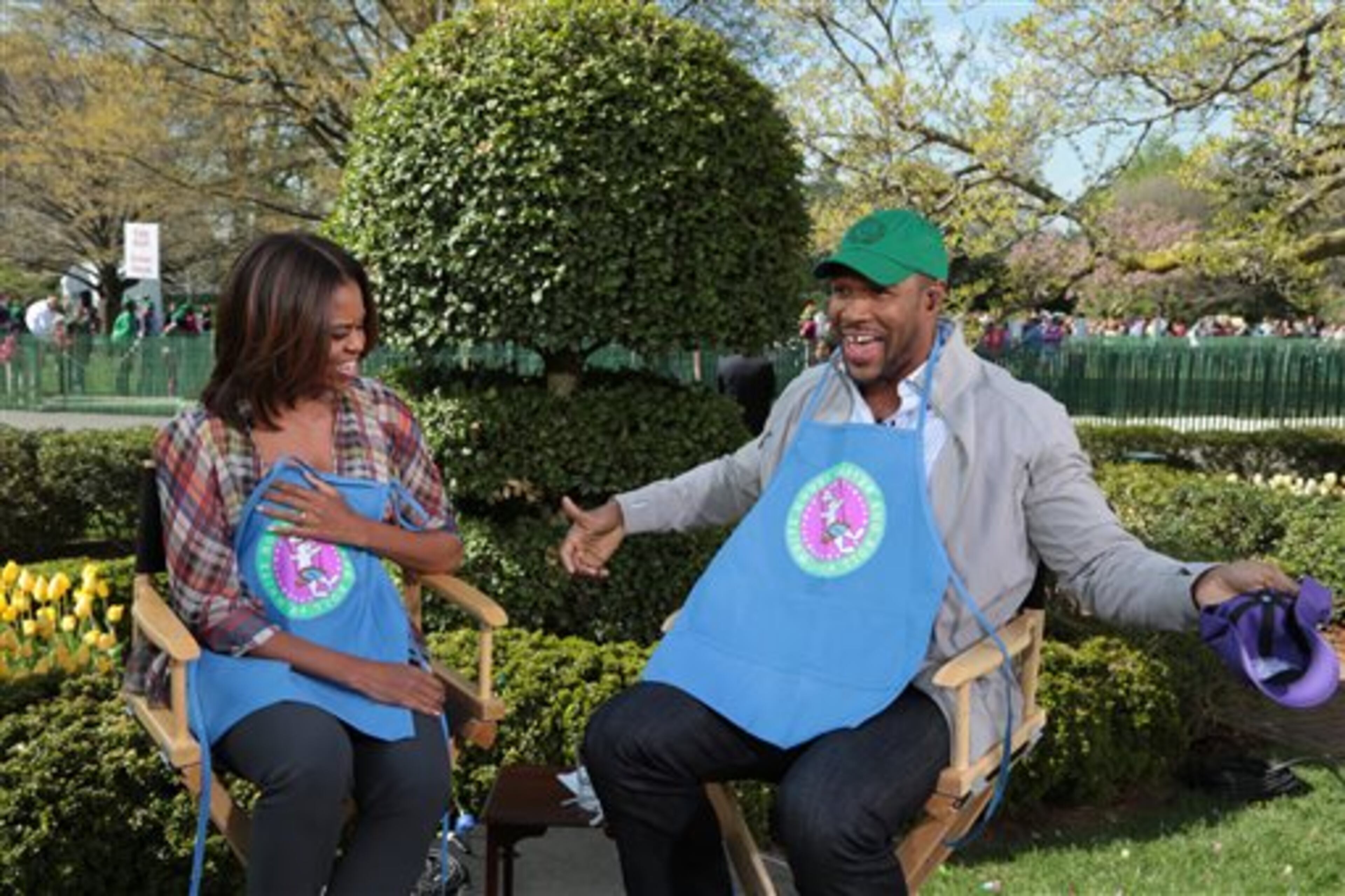 This image released by ABC shows former professional football player Michael Strahan, co-host of "Live! with Kelly and Michael," with first lady Michelle Obama, left, during the annual White House Easter Egg Roll at The White House in Washington, D.C., on Monday, April 21, 2014. (AP Photo/Disney- ABC Domestic Television, David M. Russell)
