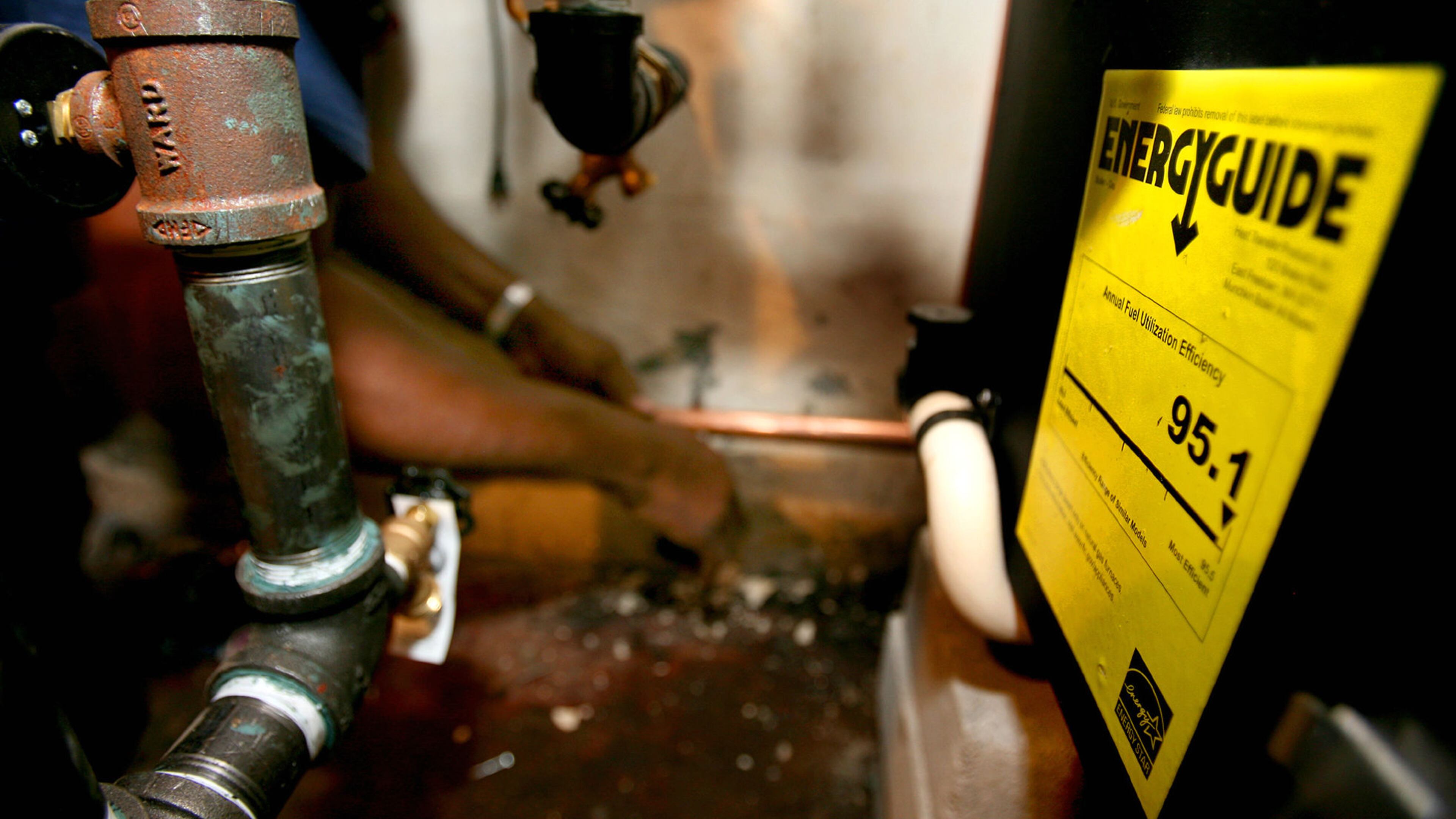 In this Aug. 8, 2008, file photo, a high-efficiency natural gas furnace, hot water heater and air conditioning system is installed at a home in Ossining, N.Y.