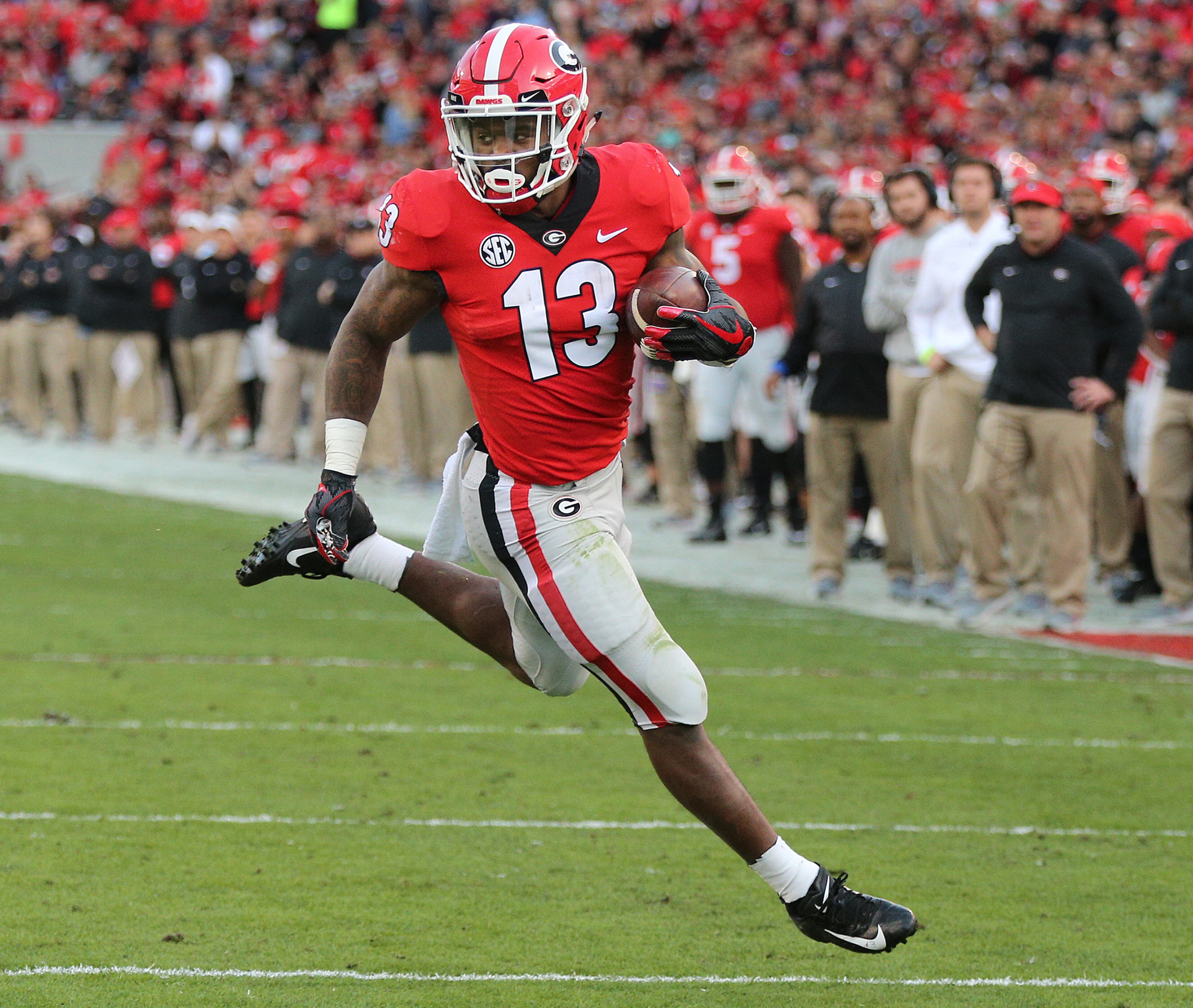 Nov 17, 2018 Athens: Georgia tailback Elijah Holyfield scorea a touchdown against Massachusetts for a 14-0 lead during the first quarter in a NCAA college football game on Saturday, Nov. 17, 2018, in Athens. Curtis Compton/ccompton@ajc.com