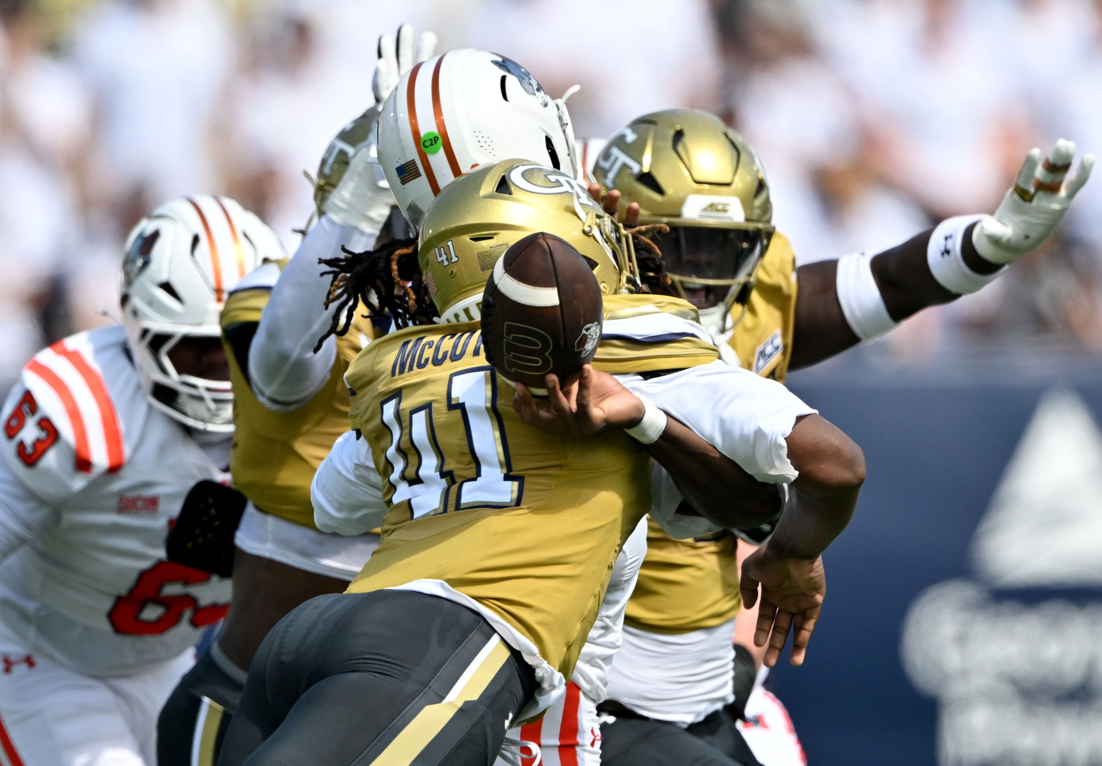 Mercer quarterback Jaylen King (2) is hit by Georgia Tech defensive end Taje McCoy (left) causing a fumble during the first half in an NCAA college football game at Bobby Dodd Stadium on Saturday, Sept. 19, 2026, in Atlanta. (Hyosub Shin/AJC)