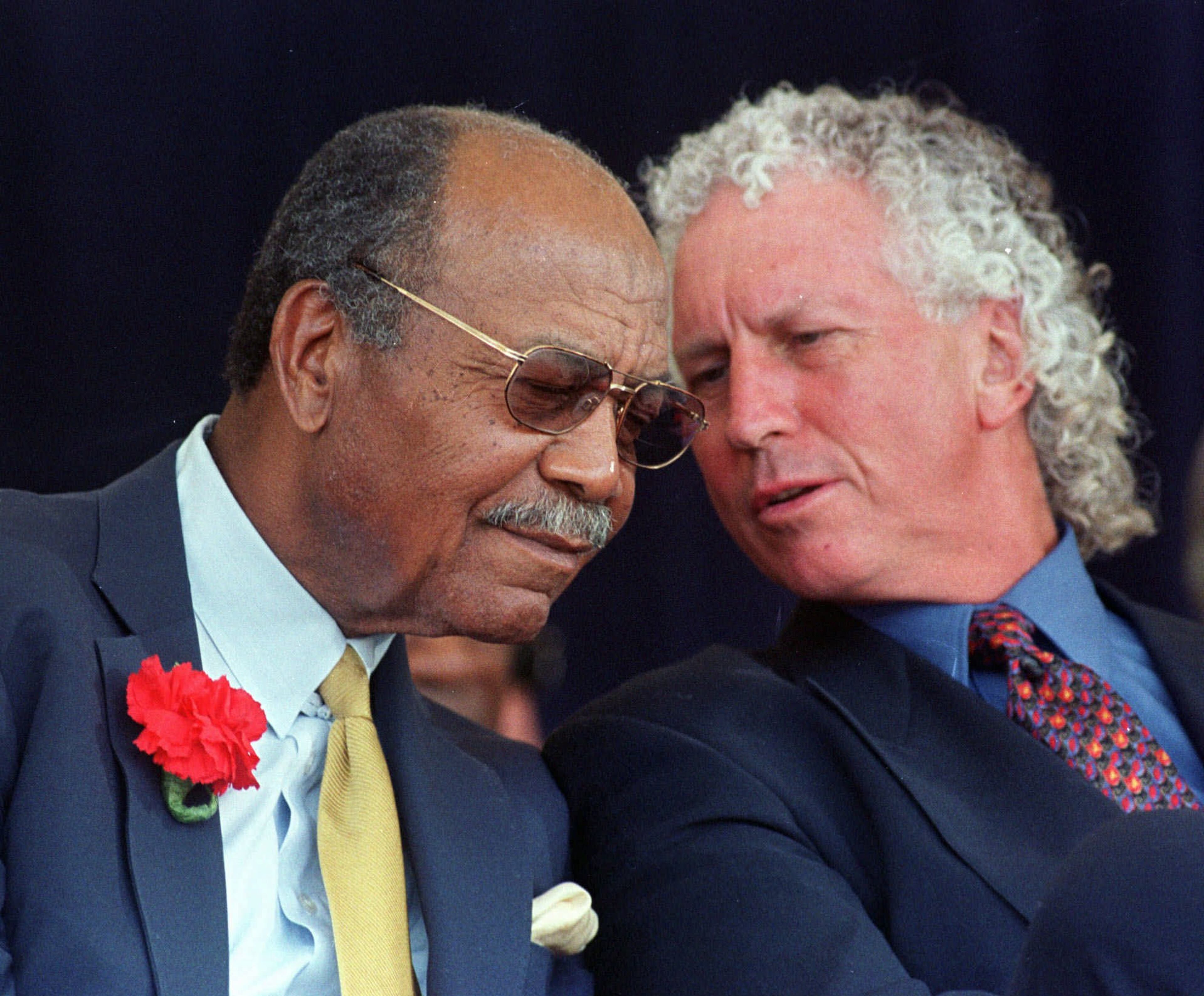 1998: Larry Doby, left, the second African-American to play in major league baseball, and pitcher Don Sutton talk Sunday, July 26, 1998, at the beginning of their induction into the Baseball Hall of Fame in Cooperstown, N.Y. They were among five inducted into the hall. (AP Photo/Rusty Kennedy)
