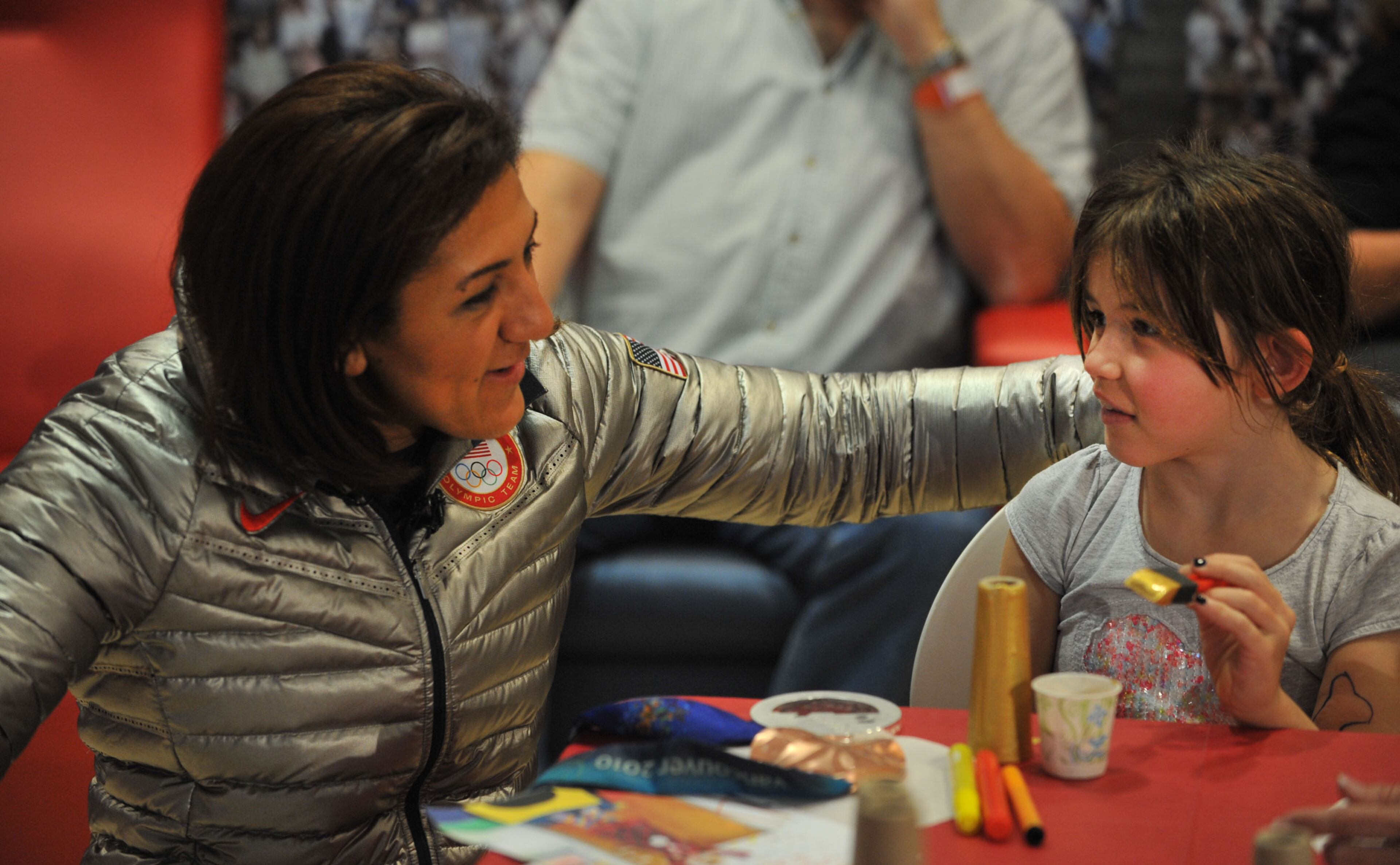 Douglasville-native Elana Meyers chats with Clara Jolley, 7, of Mabelton, during a visit to The Zone at Children's Healthcare of Atlanta at Scottish Rite on Monday, Feb. 24, 2014. KENT D. JOHNSON / KDJOHNSON@AJC.COM