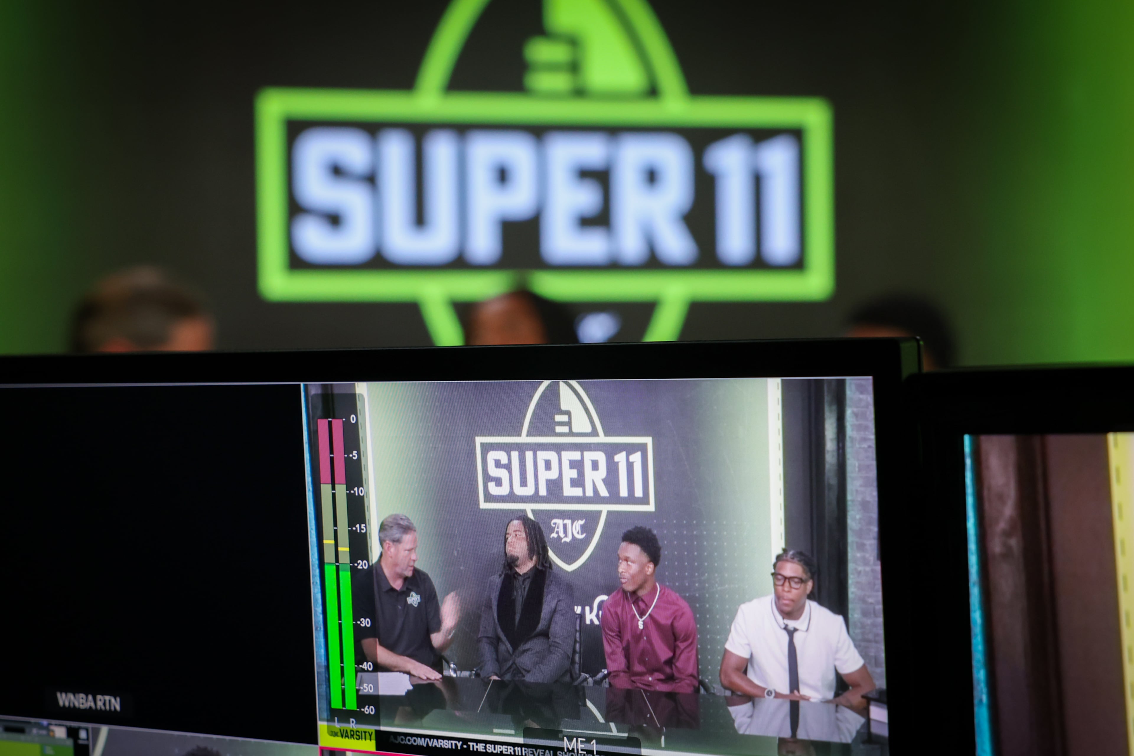 (L-R) DawgNation’s Brandon Adams interviews Northside’s Elijah Patmon, Lee County’s Jaden Upshaw and Howard’s Ta'Shawn Poole during the taping of the Super 11 reveal show at Score ATL in Roswell on Aug. 3, 2026. (Arvin Temkar/AJC)