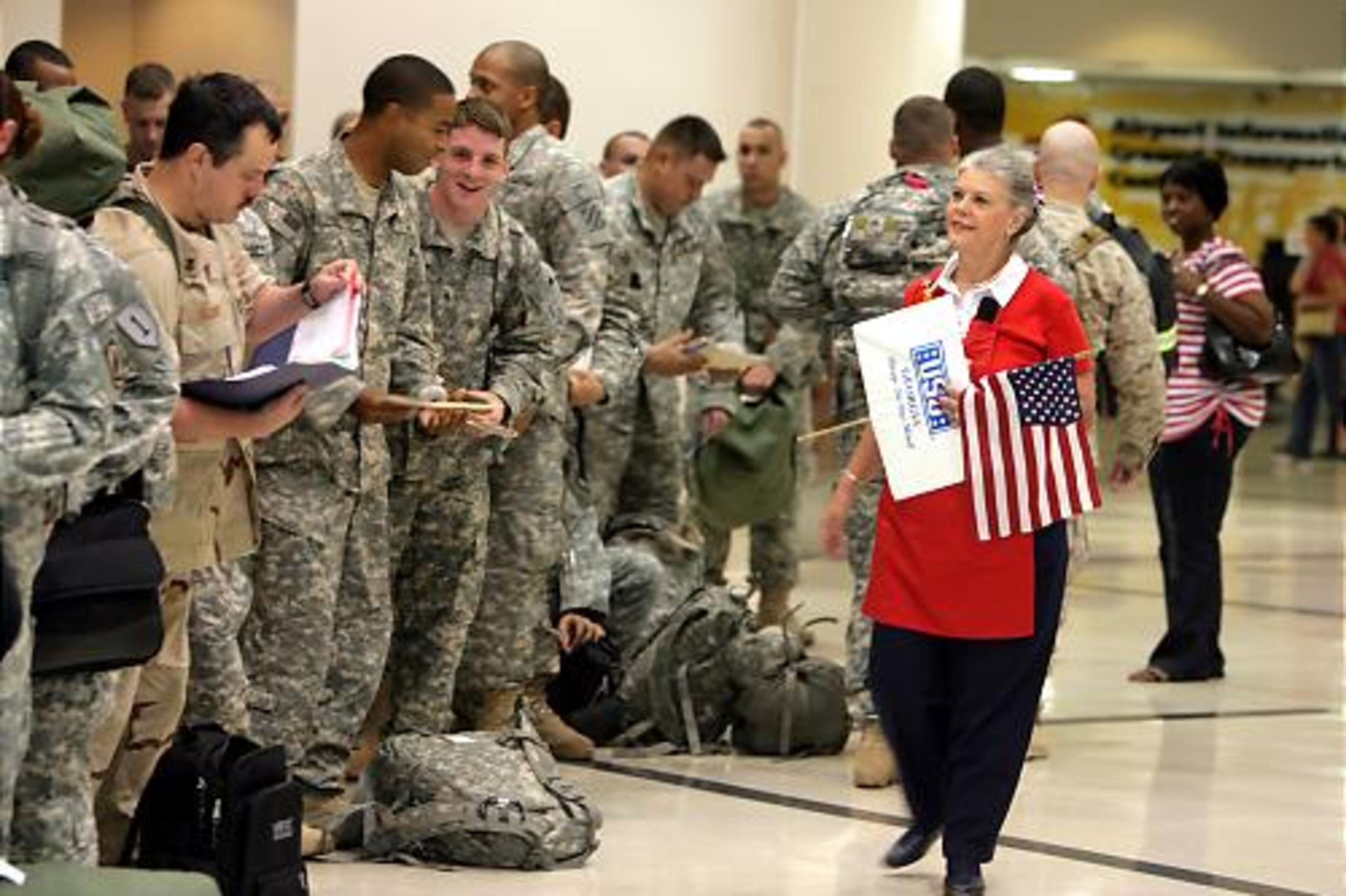 USO volunteer Bette Rose Bowers lines up soldiers who are returning to Iraq.