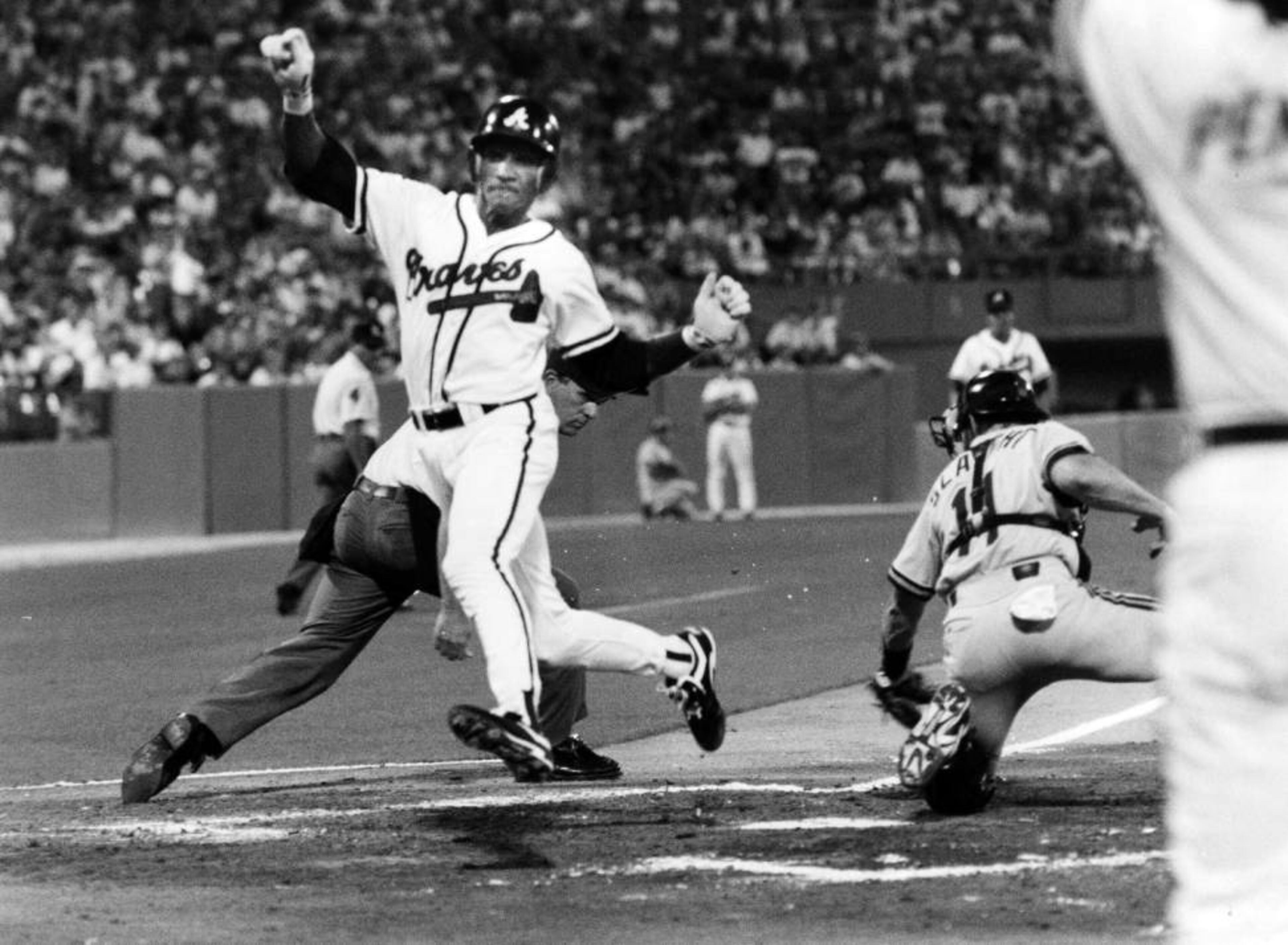 Otis Nixon scores in the 6th inning for the Atlanta braves in a game against the Pirates on July 15, 1993. The Braves won 4-0.