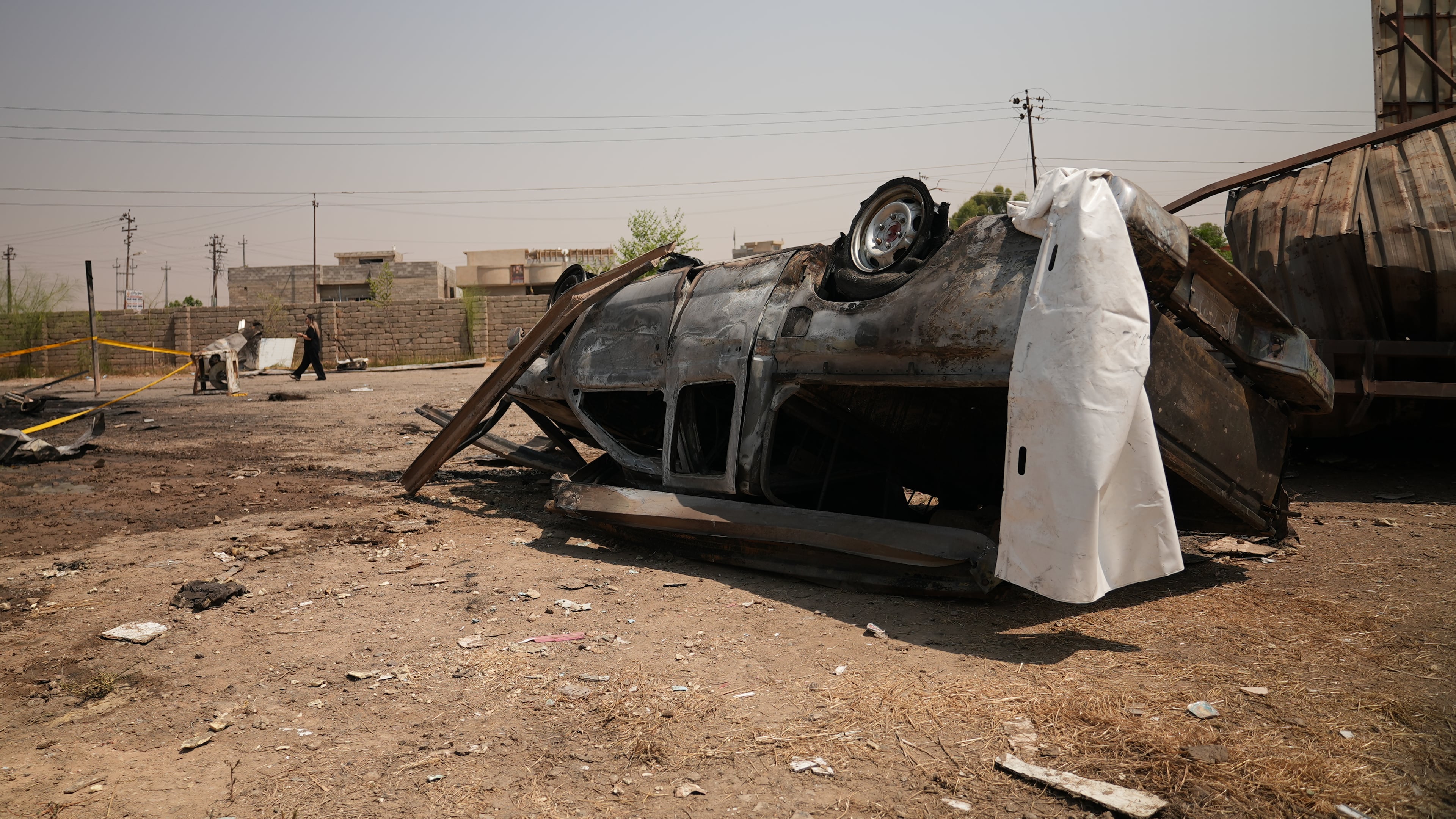 A damaged vehicle at the site of an airstrike on a Popular Mobilization Forces base in Mosul, Iraq, Wednesday, July 29, 2026. (AP Photo/Farid Abdulwahed)