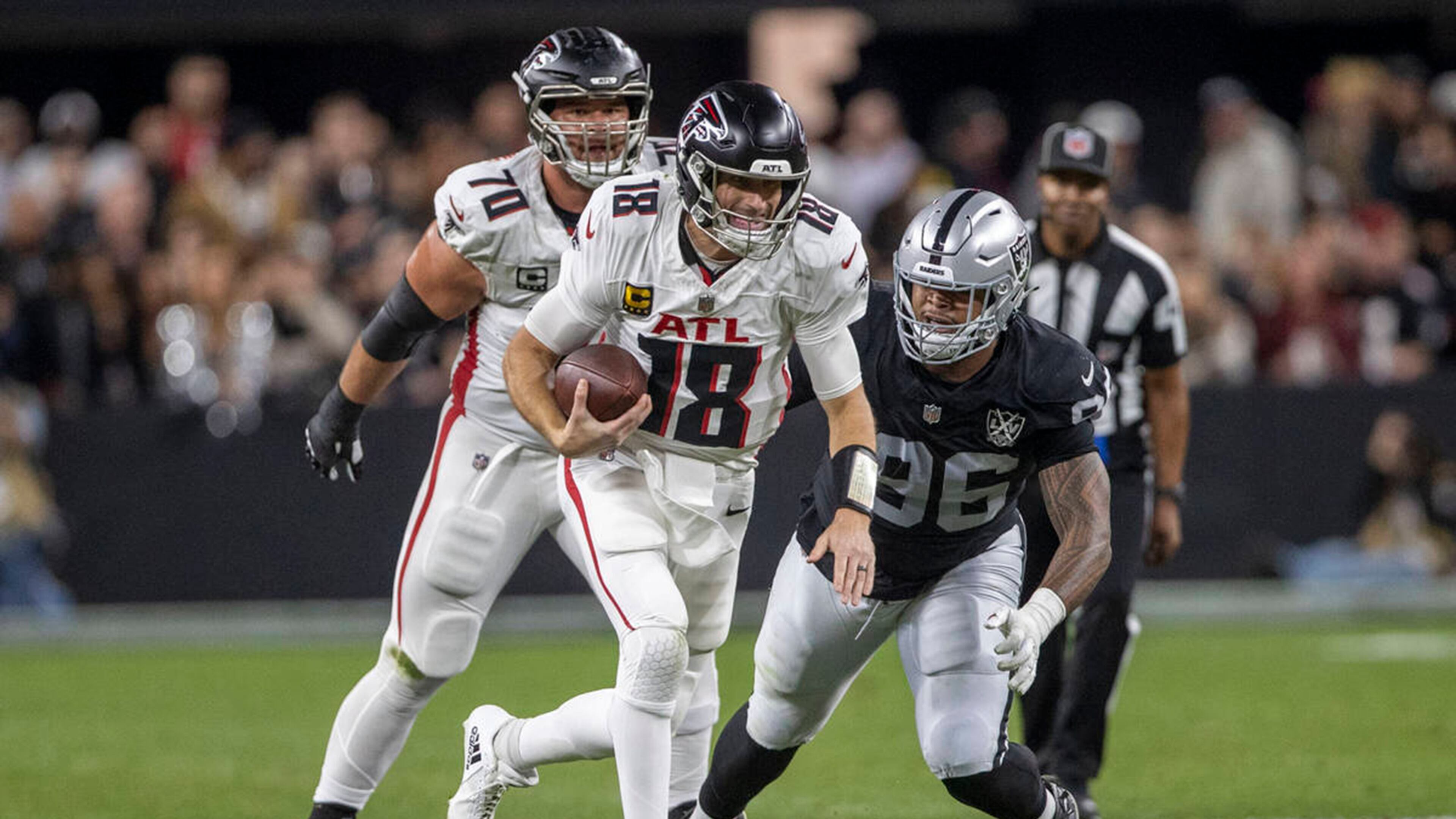 Las Vegas Raiders defensive tackle Jonah Laulu (96) pursues Atlanta Falcons quarterback Kirk Cousins (18) during the first half of an NFL game on Monday, Dec. 16, 2024, at Allegiant Stadium in Las Vegas. (Heidi Fang/Las Vegas Review-Journal/TNS)