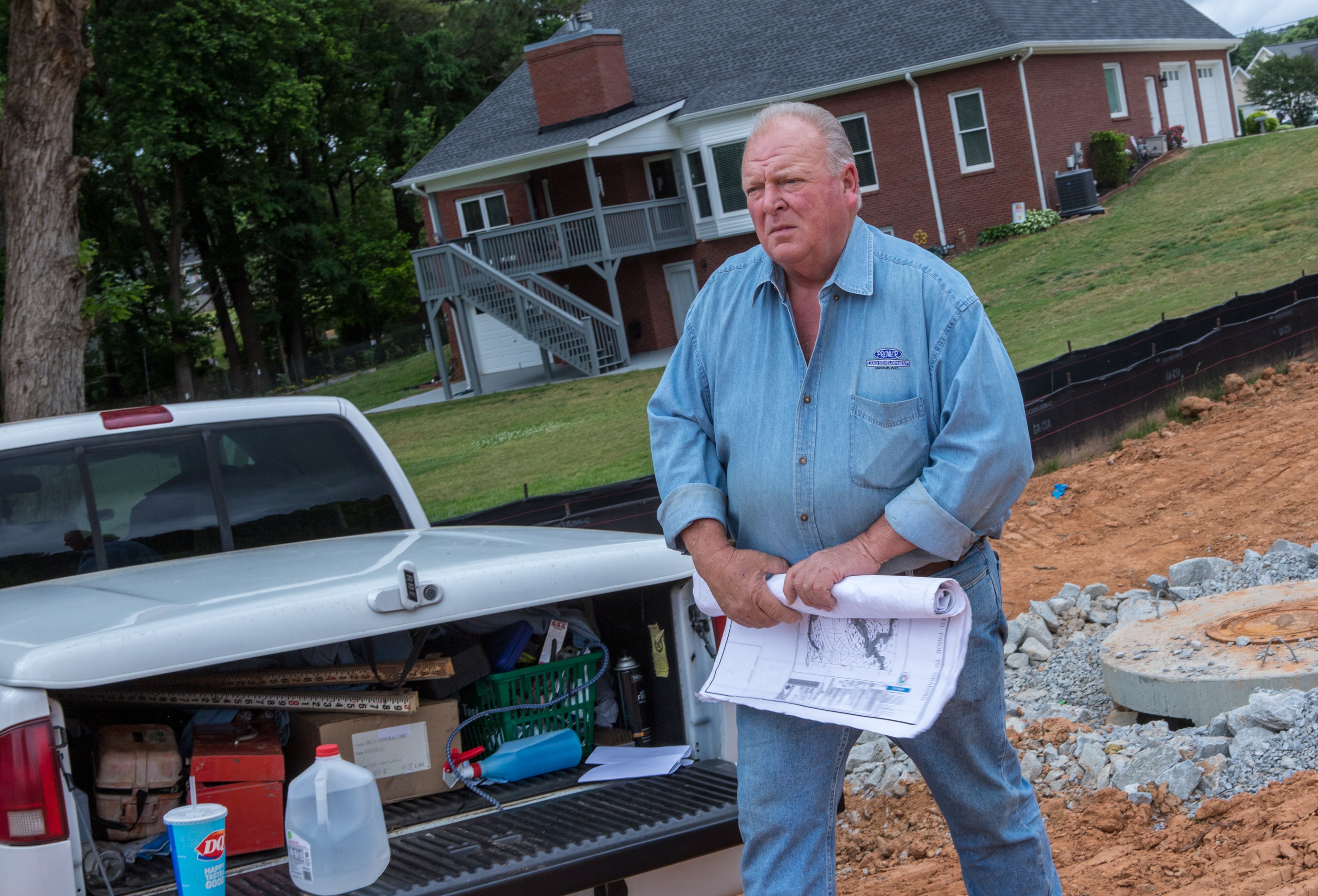 Stoney Birt works in Sugar Hill to prepare for a new subdivision on Friday, May 13, 2022. Stoney has written a book about his father, Billy Sunday Birt, a convicted killer who repented in prison before his passing. Stoney and his brother are writing competing books about the family patriarch. (Jenni Girtman for The Atlanta Journal-Constitution)