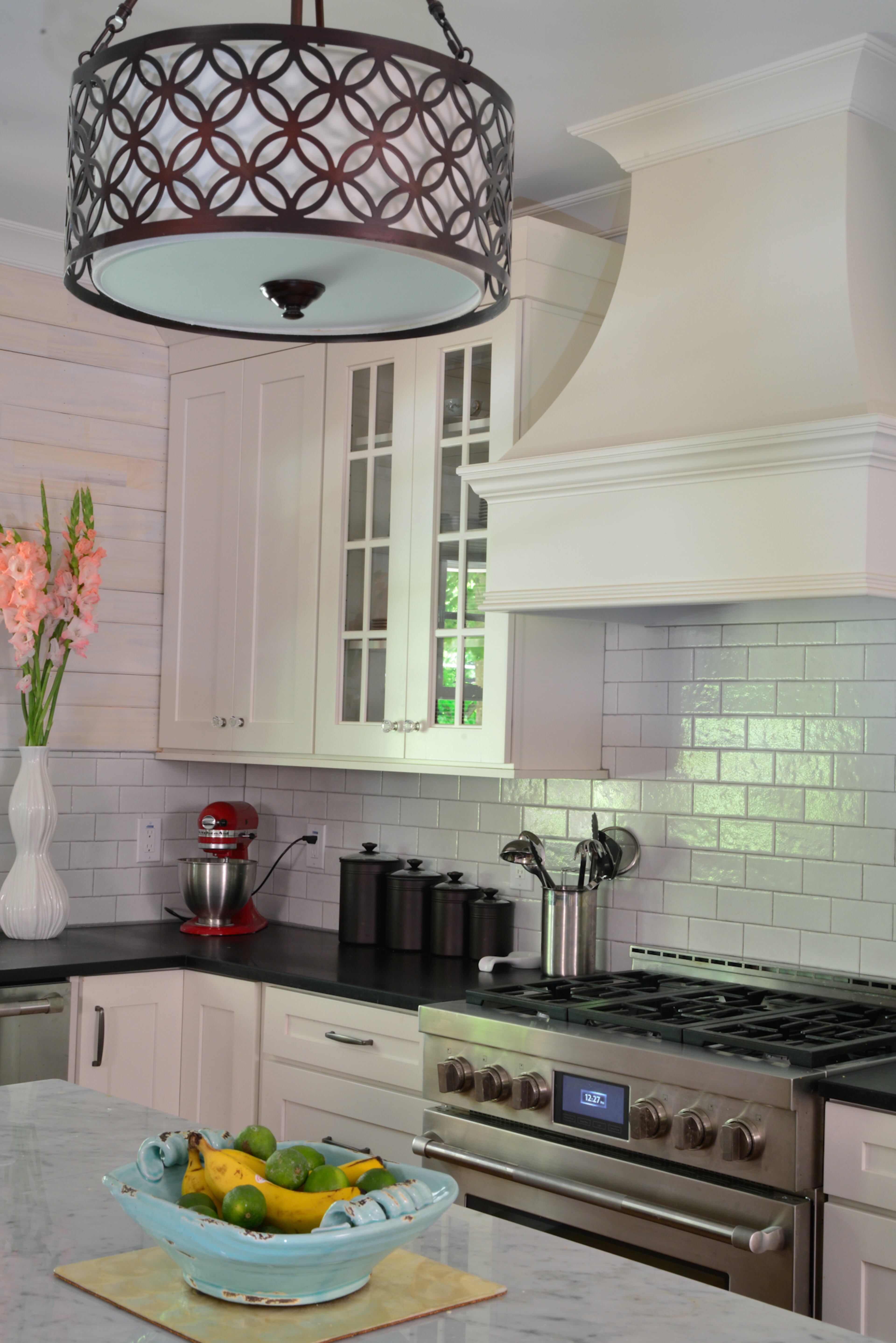 Kitchen: The kitchen has a crackled subway tile backsplash and black honed granite countertops. The light fixture over the island is from Lowe's.