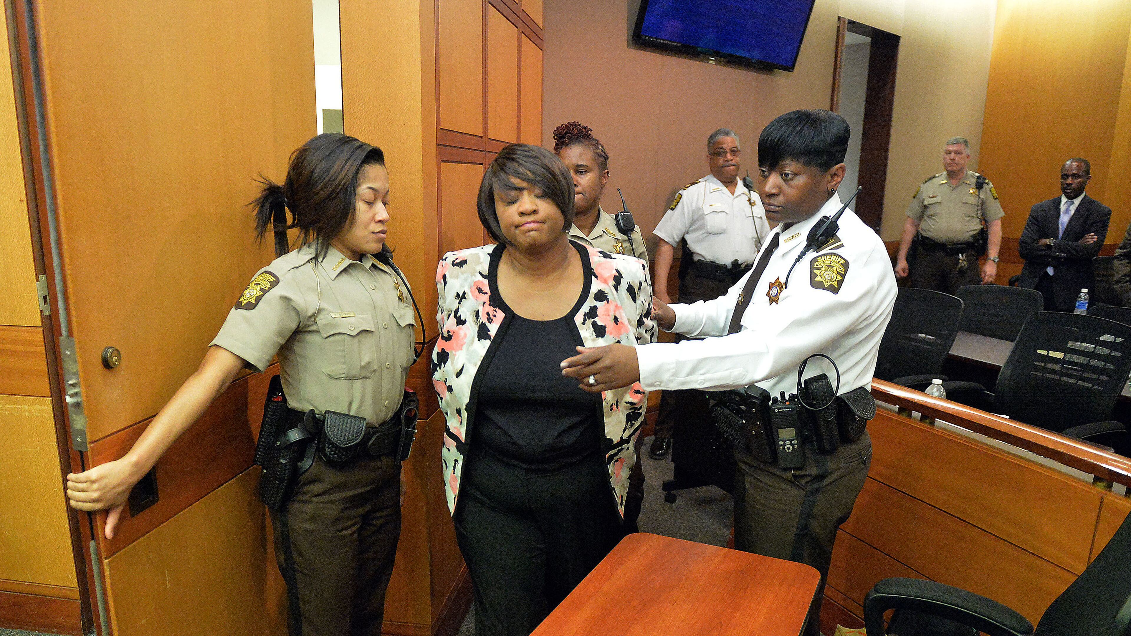 Former Atlanta Public Schools School Reform Team Director Tamara Cotman is led to a holding cell after a jury convicted her of a racketeering charge on April 1, 2015. Public-records requests uncovered information showing educators engaged in a conspiracy to inflate test scores. (AJC FILE PHOTO)