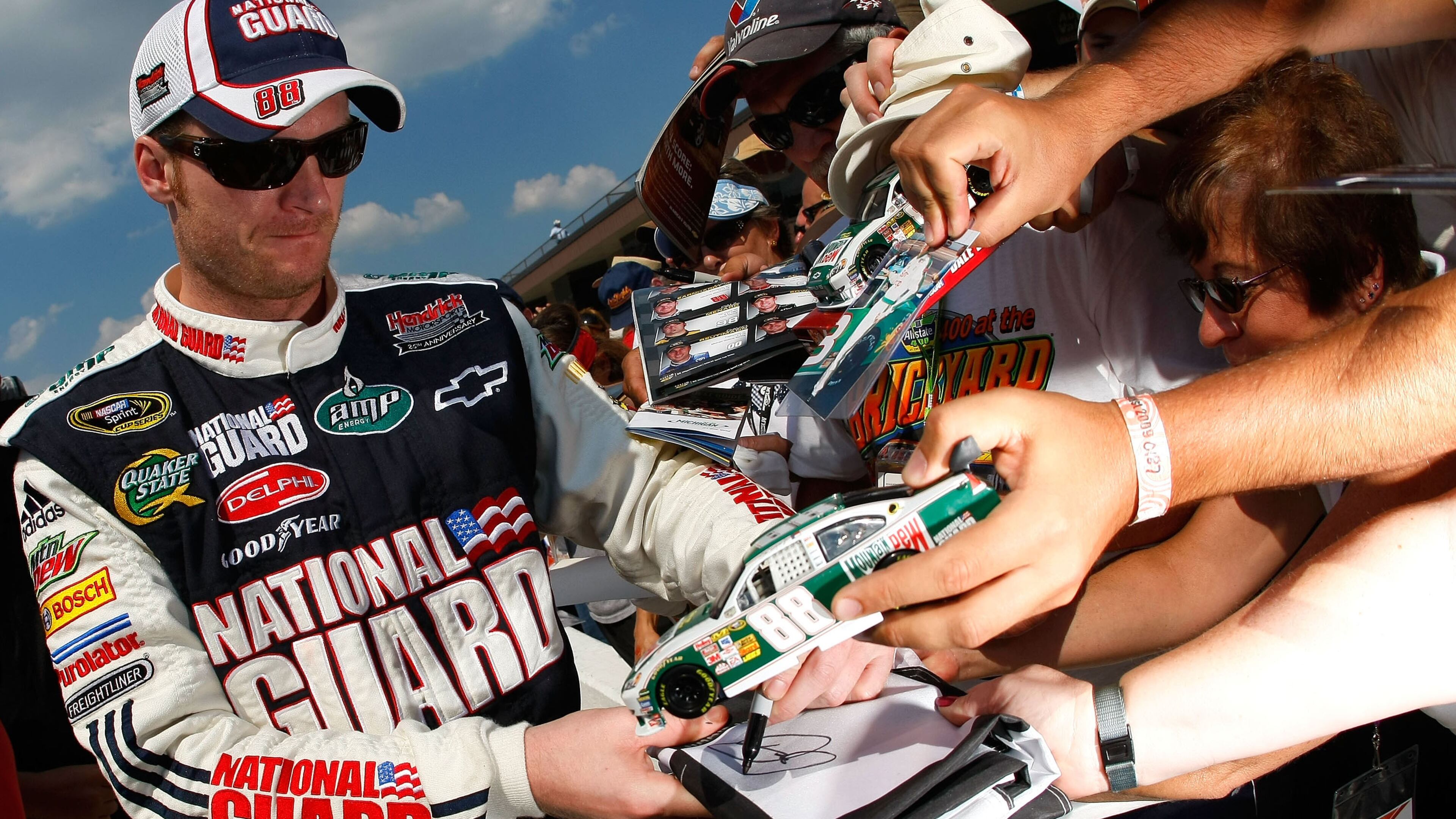BROOKLYN, MI - AUGUST 14: Dale Earnhardt Jr., driver of the #88 AMP Energy/National Guard Chevrolet, signs autographs for fans after qualifying for the NASCAR Sprint Cup Series Michigan 400 at Michigan Internetional Speedway on August 14, 2009 in Brooklyn, Michigan. (Photo by Jason Smith/Getty Images)