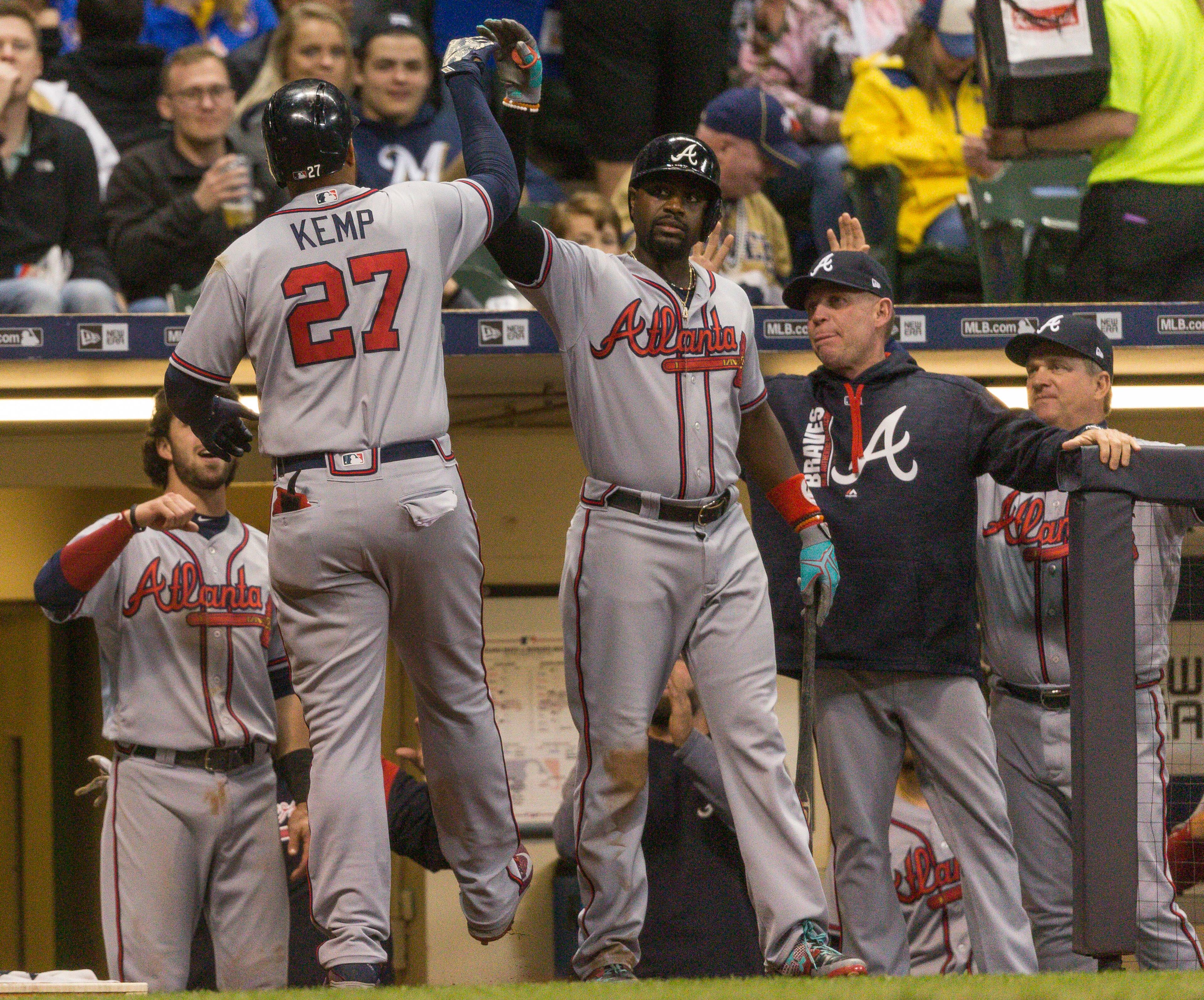 Atlanta Braves' Matt Kemp gets a high-five from teammates after hitting his second home run of a baseball game off Milwaukee Brewers' Tommy Milone during the seventh inning Saturday, April 29, 2017, in Milwaukee. (AP Photo/Tom Lynn)