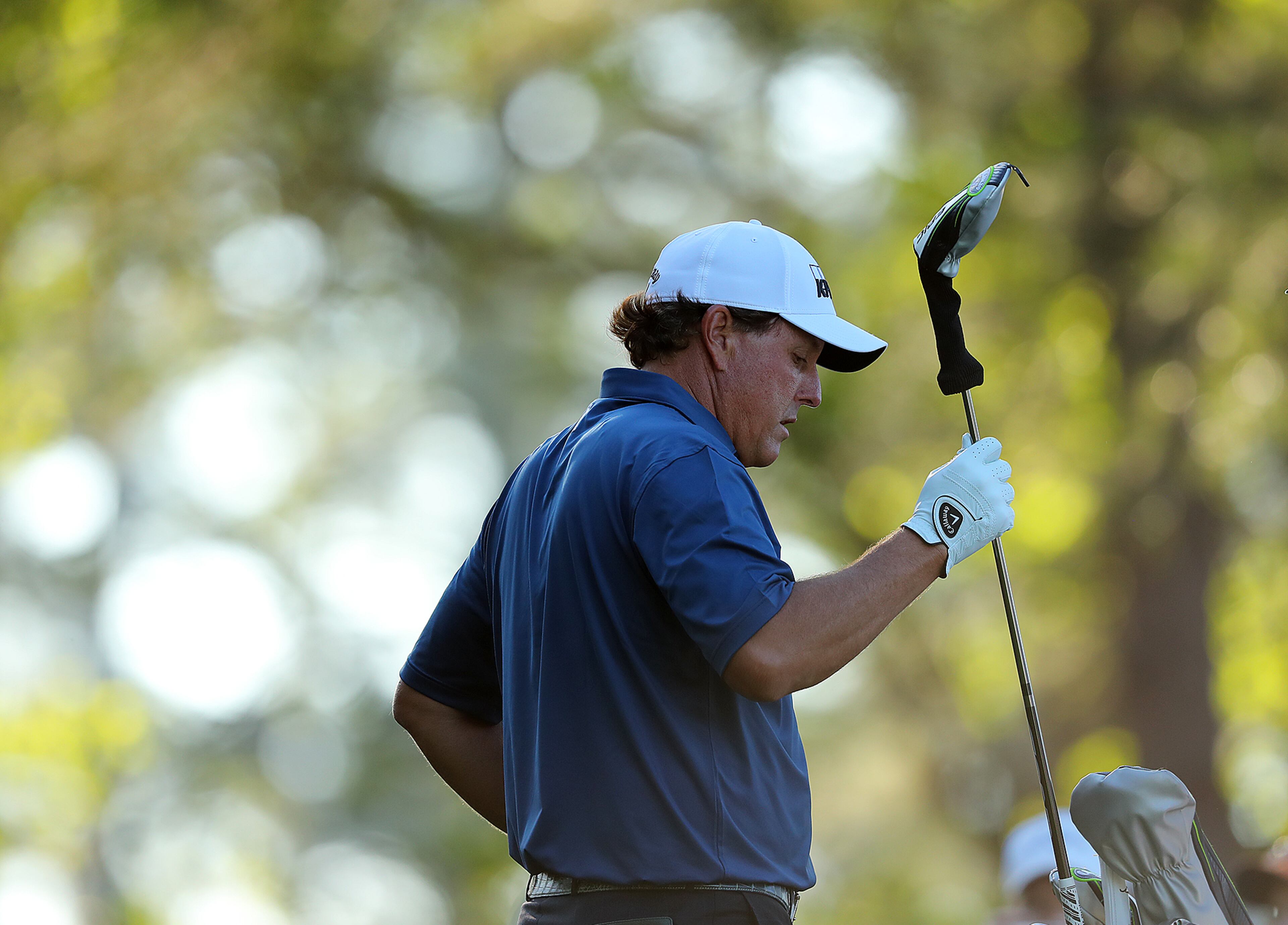 Phil Mickelson selects his club on the fourth tee on his way to a birdie during his practice round Tuesday.