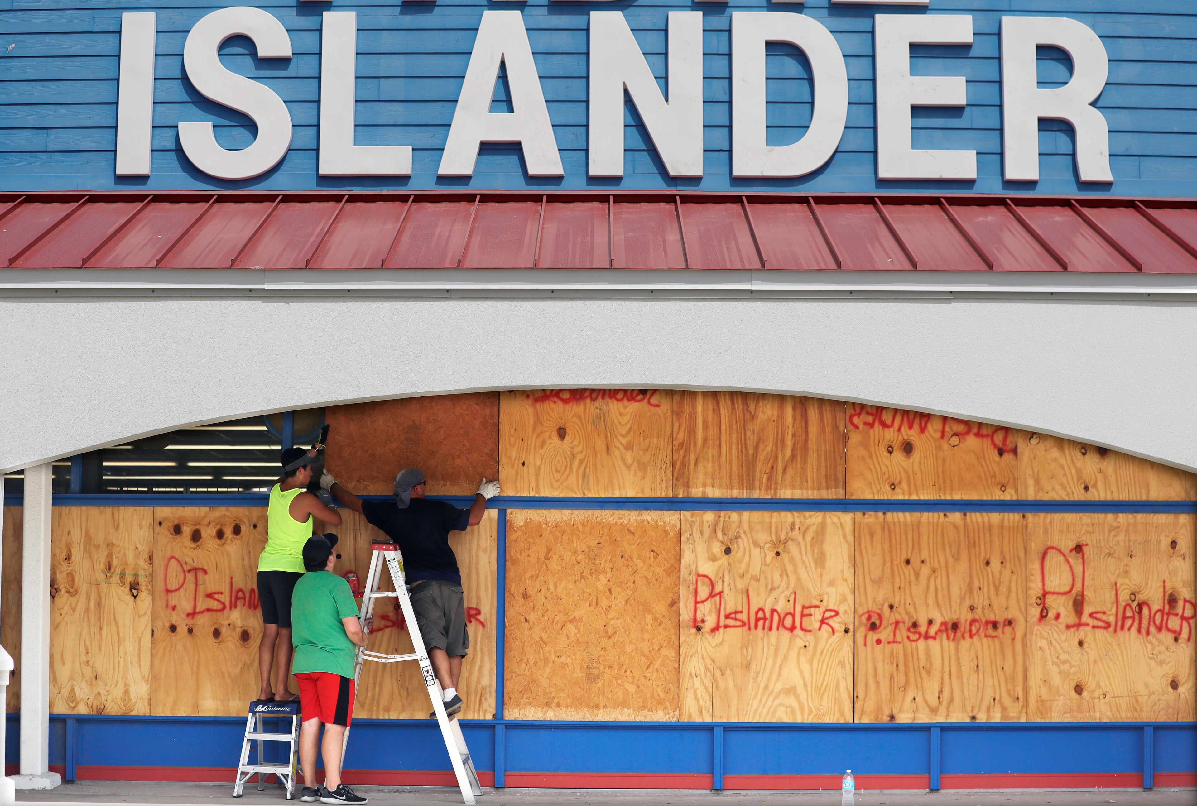 Workers cover a business with plywood in preparation for Hurricane Harvey, Thursday, Aug. 24, 2017, in Corpus Christi, Texas. (AP Photo/Eric Gay)