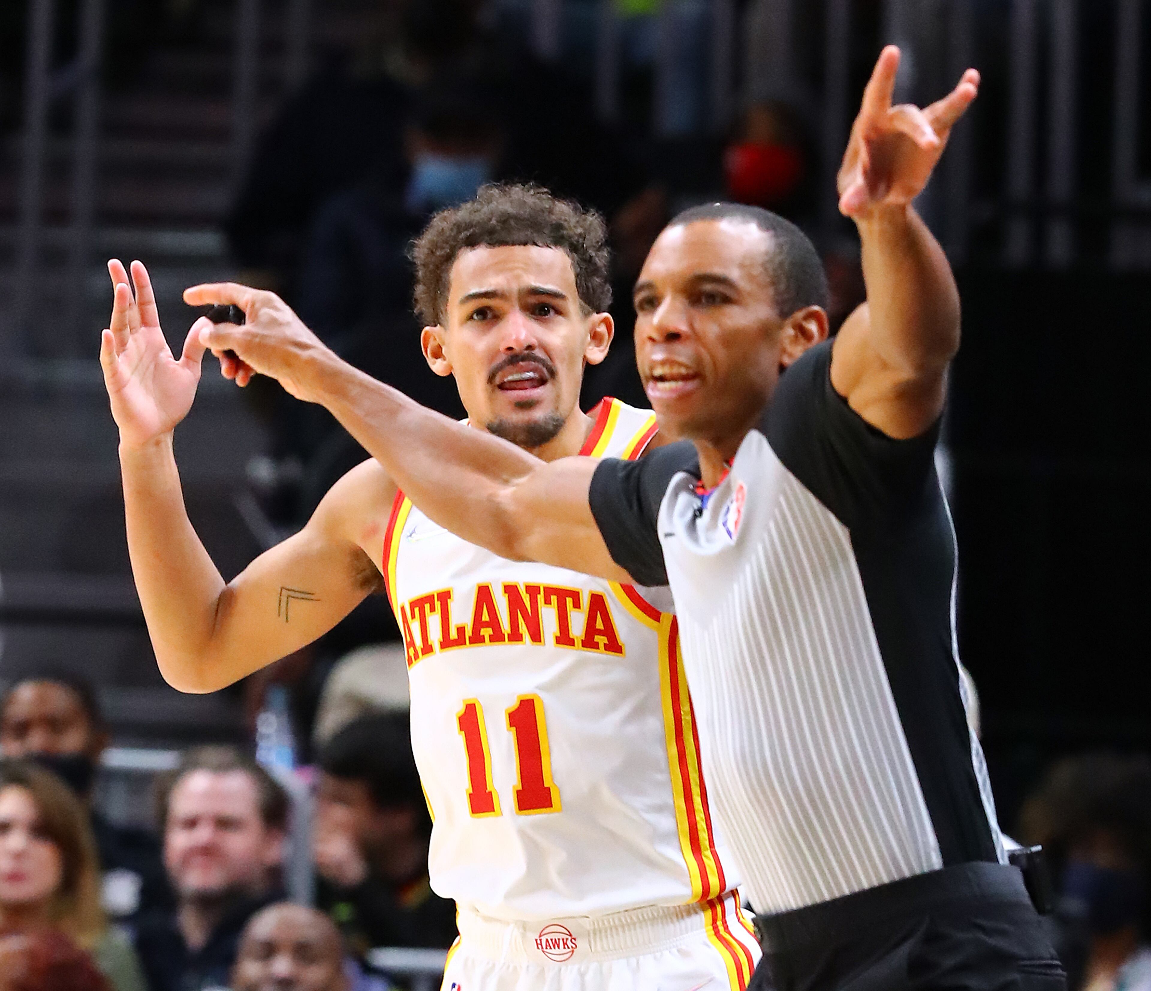 Hawks guard Trae Young reacts as an official calls him for an offensive foul on a three-point shot against the Oklahoma City Thunder during the 4th period. The call was overturned on a challenge by Hawks coach Nate McMillan and Young was awarded the three-point basket on the play. “Curtis Compton / Curtis.Compton@ajc.com”
