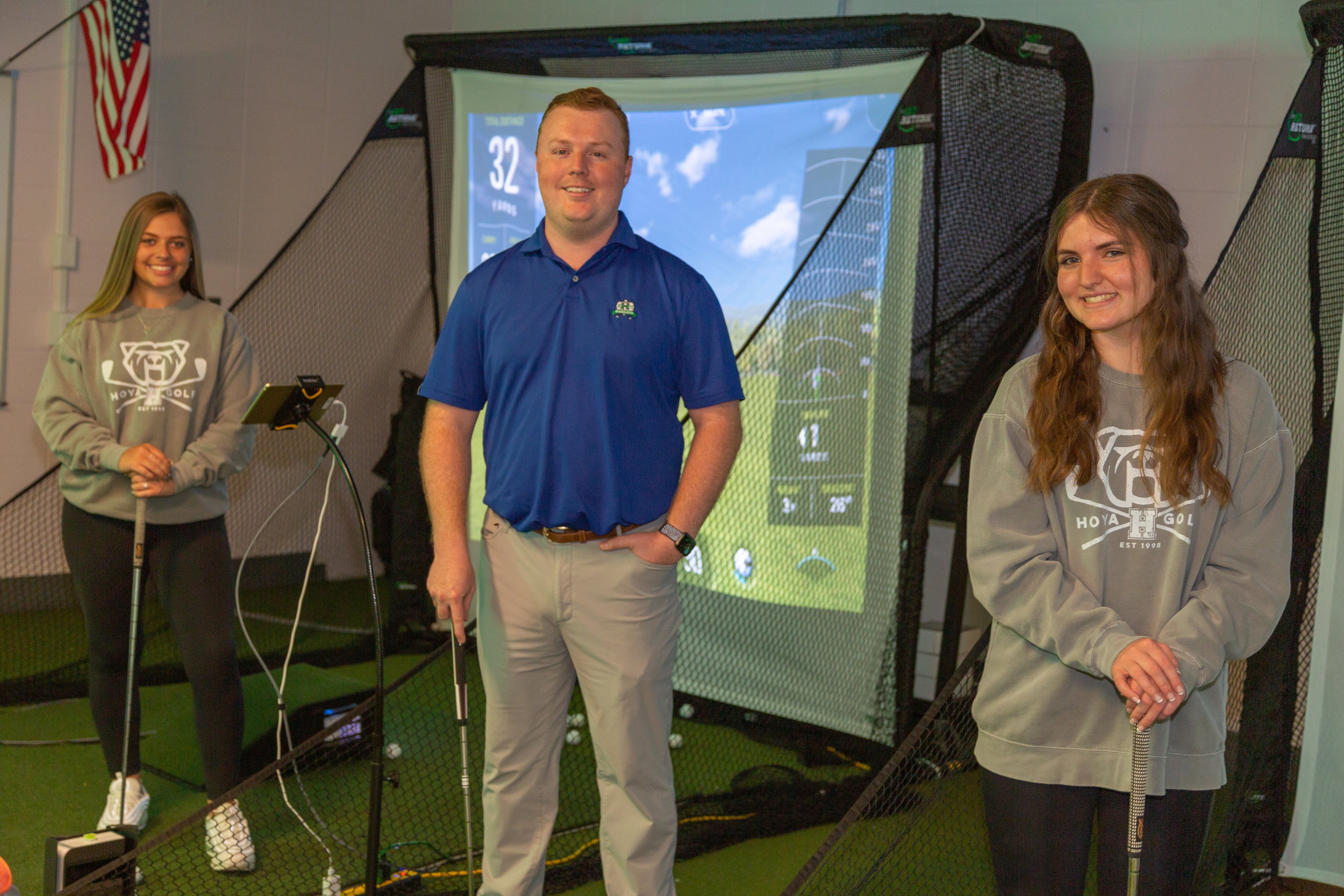 (From left) Haven Blank, coach Travis Farmer and Olivia Kirkland enjoy the new indoor practice facility at Harrison High School. (Hunter Cook photo)