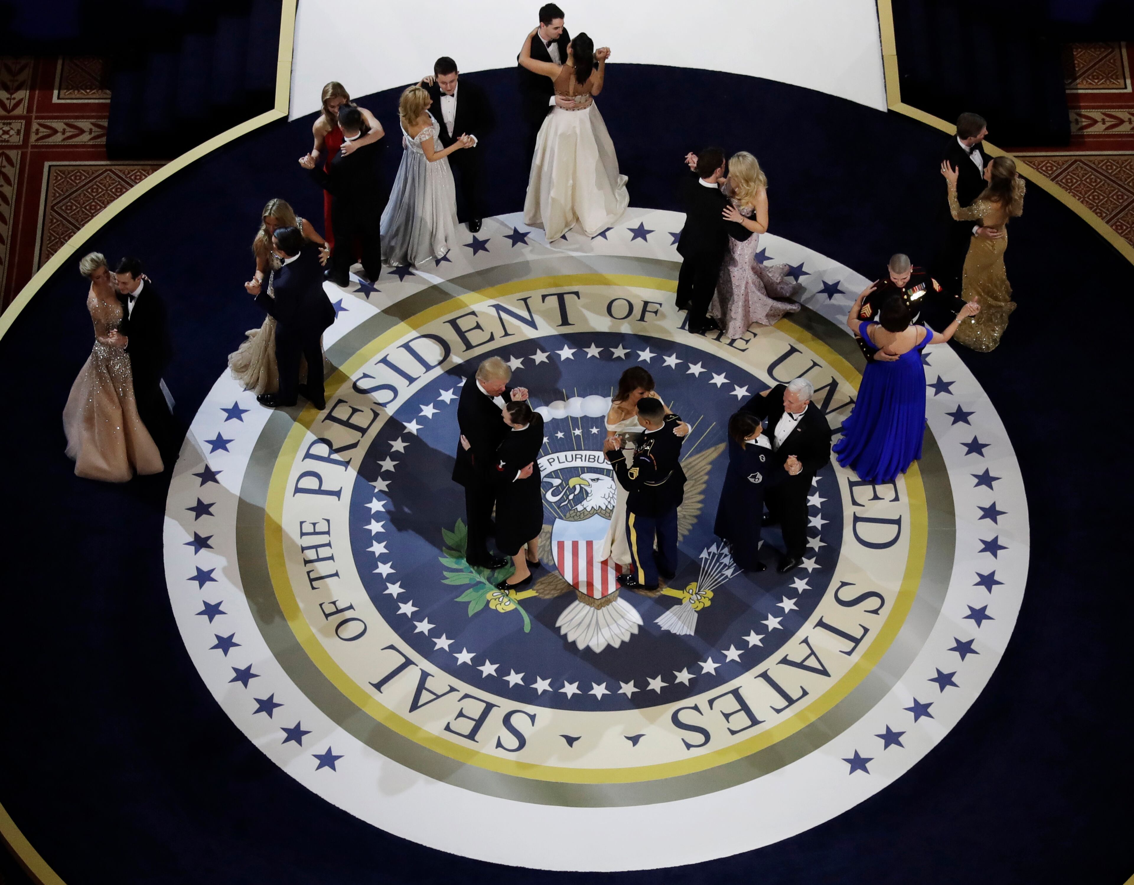 President Donald Trump and first lady Melania dance with military personnel during the Salute to Armed Forces Ball for President Donald Trump at the National Building Museum in Washington, Friday, Jan. 20, 2017. (AP Photo/David J. Phillip)