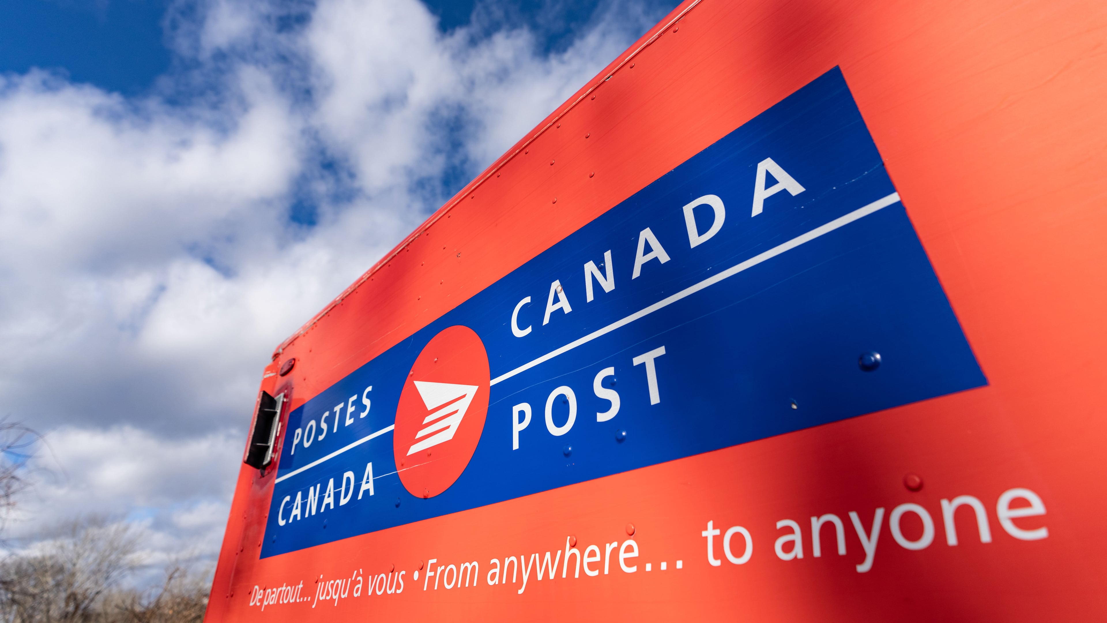 FILE - A Canada Post mail truck is seen parked in their distribution center, in Montreal, Nov. 27, 2024. (Christinne Muschi/The Canadian Press via AP, File)