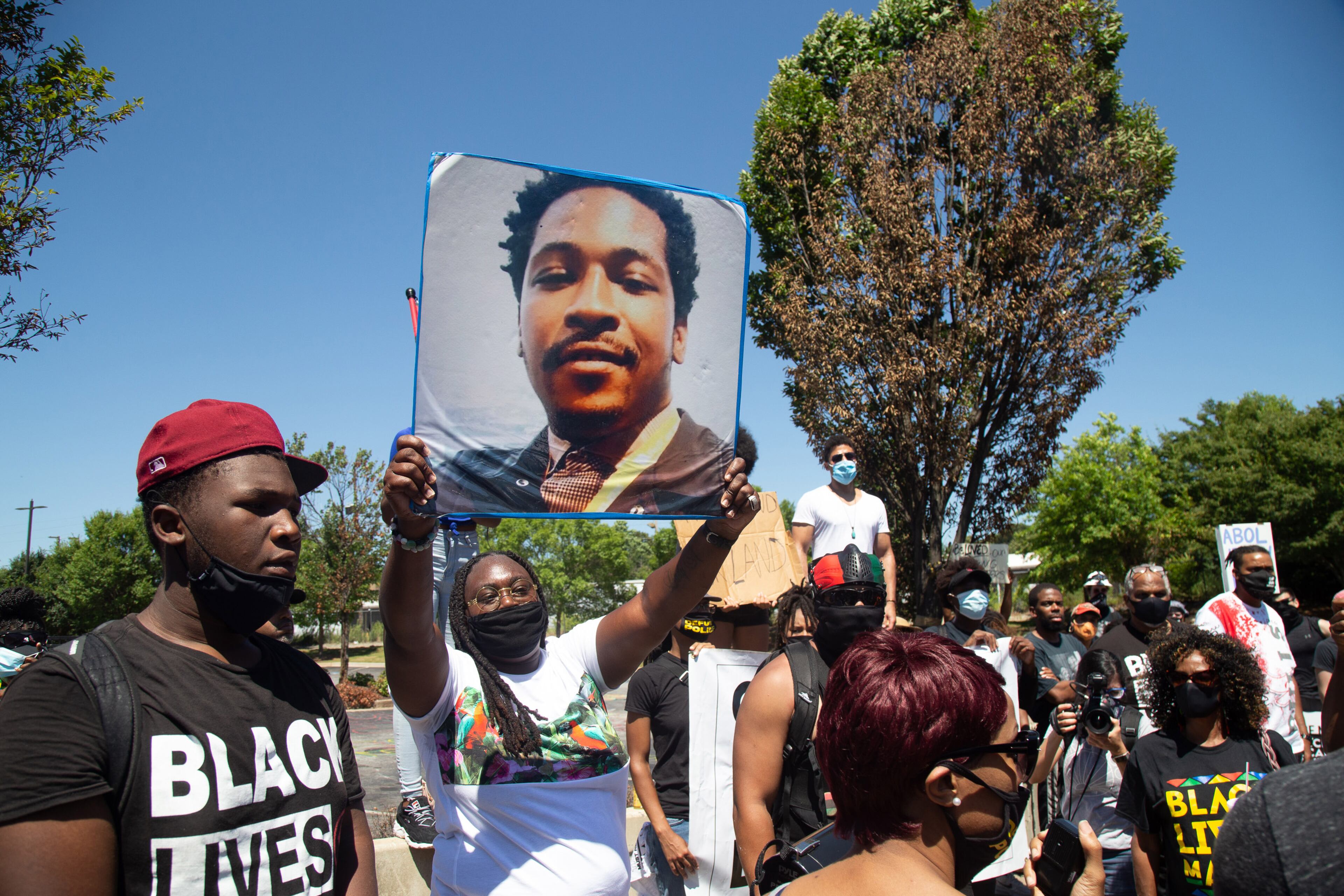 A protester holds up a sign during the 'Take Back the Wendy's' March & Rally on University Avenue in Atlanta on Saturday, July 11, 2020. The march started at the Community Movement Builders community house and ended at the Wendy's. STEVE SCHAEFER FOR THE ATLANTA JOURNAL-CONSTITUTION